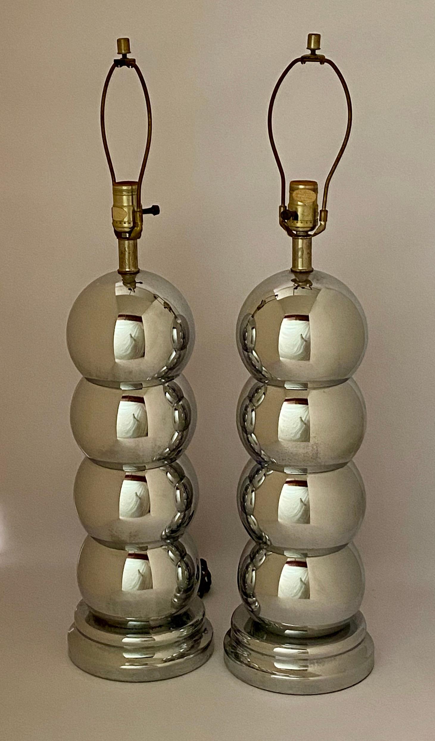 Fine pair of polished chrome caterpillar table lamps. Good overall condition with working wiring. Harps included. Shades not included. Some light pitting around bases, circa 1970.

Approximately 29