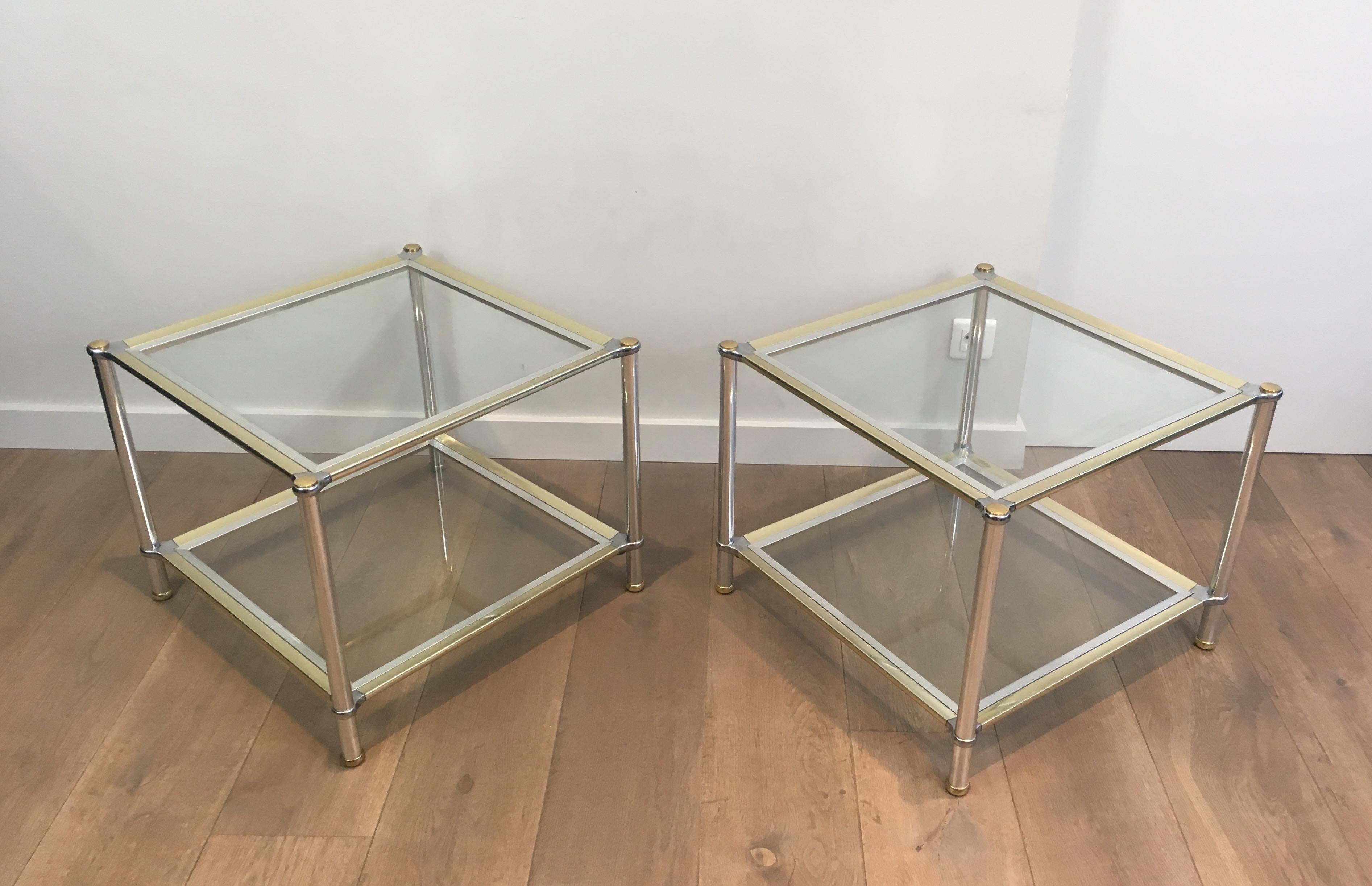 This pair of side tables is made of chrome, gilt and silver metal with clear glass. This is a beautiful model, very decorative. These en tables are French, circa 1970.