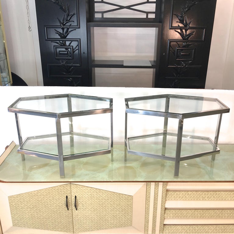 Charming vintage polished chrome casket shaped hexagonal tables with two tiers of inset glass. These were purchased in London but I believe they are from Belgium. Nicely constructed frames.