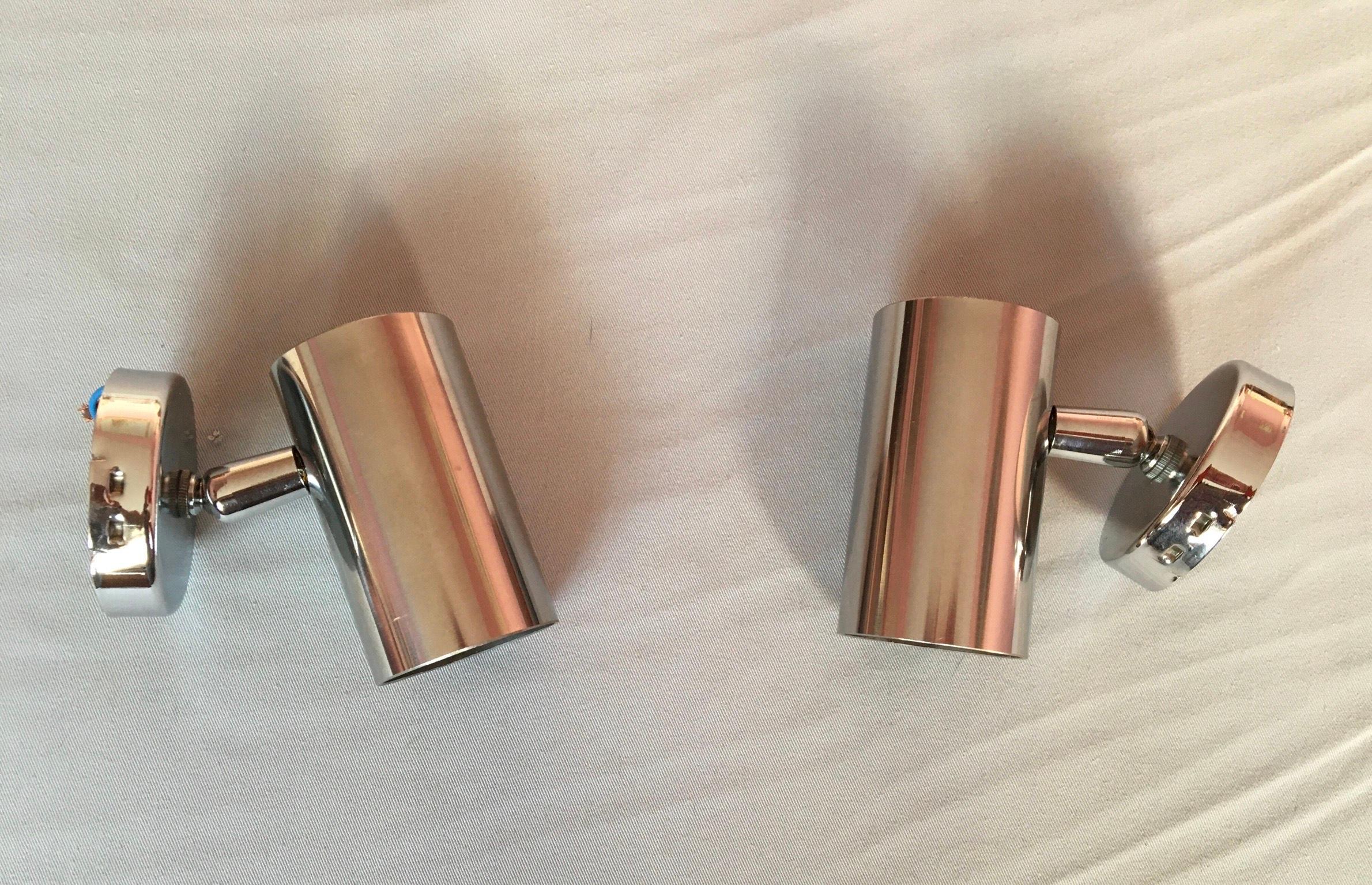 Pair of chrome heavy steel wall light spots of the 60's. 
The wall lights are in beautiful condition, they are mounted on ball joints allowing multidirectional lighting. They never have been mounted, they have their original ceramic screw bulb