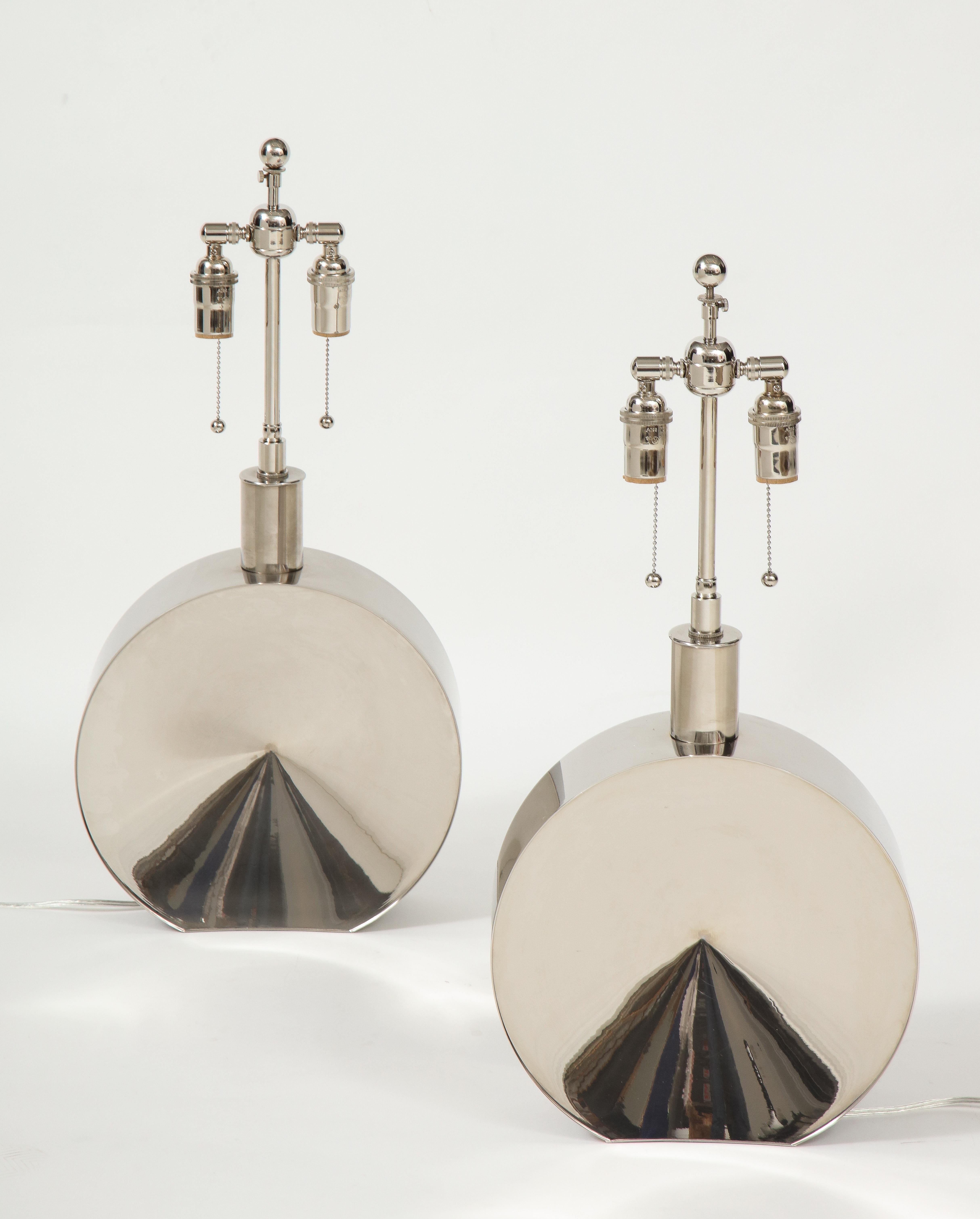 Pair of stunning chrome lamps acquired directly from a Steve Chase interior.
The beautifully constructed chrome lamp bodies have a slight convex design shape to them 
and they have been newly rewired with polished chrome adjustable double