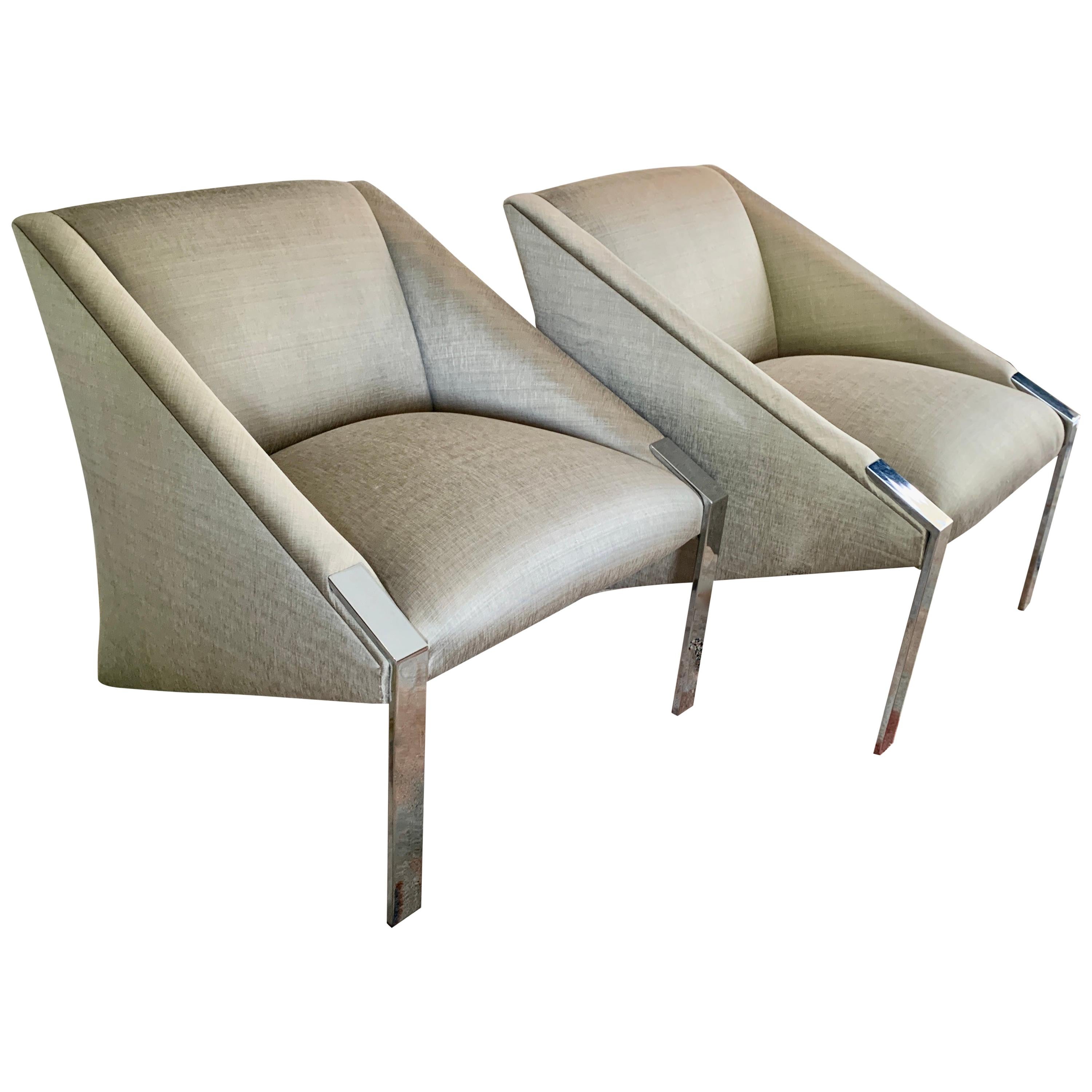 Pair of Andree Putman chrome side / lounge chairs. 

The pair rest on high polished chrome legs and slant back to meet the ground. They are reupholstered in a very chic silver tone woven silk fabric - wonderful for any room. The lines and form truly