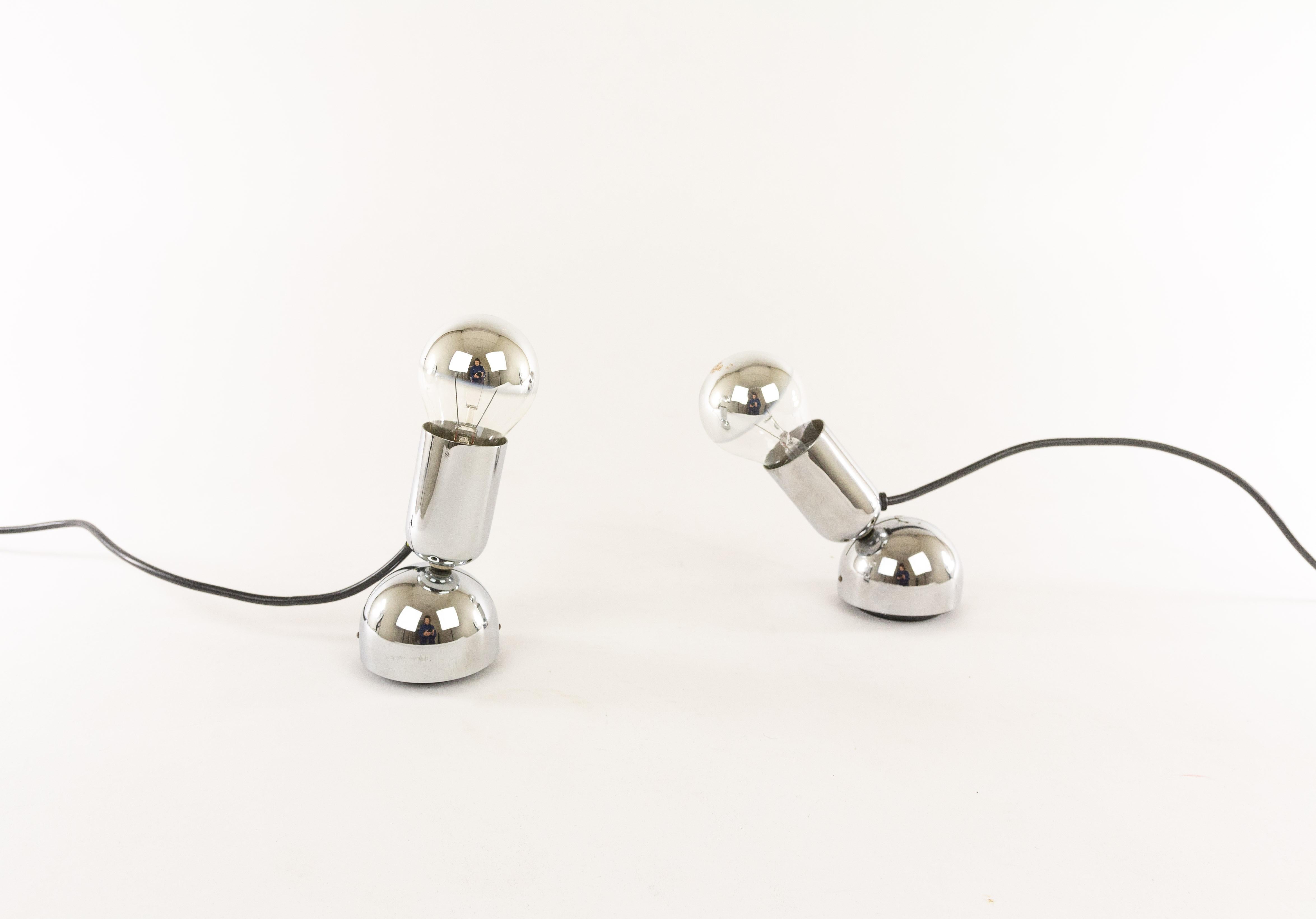 A pair of chrome Pollux table or wall lamps designed by Ingo Maurer and produced by his own company Design M.

Pollux consists of a relatively heavy base, a tube which contains the socket and that swivels on its axis and an -indispensable- half