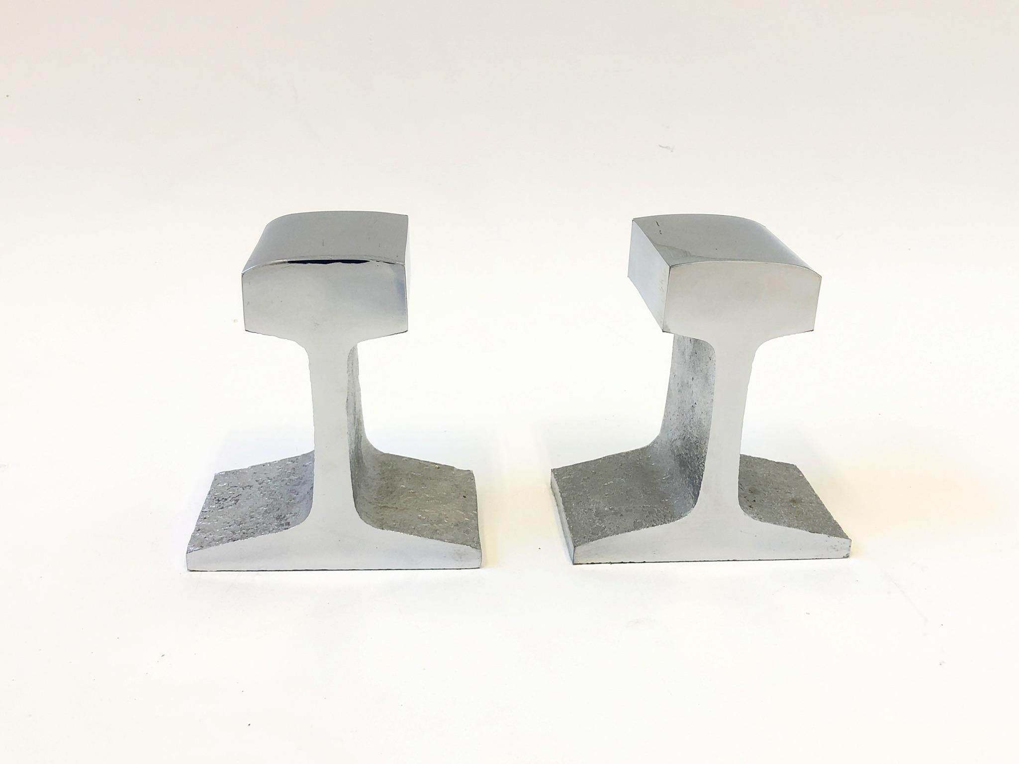Pair of 1970’s polish chrome railroad tracks bookends in the manner of Bill Curry. 
This show minor wear consistent with age. 
Measurements: 5.5” wide, 3” deep and 6” high. (each).