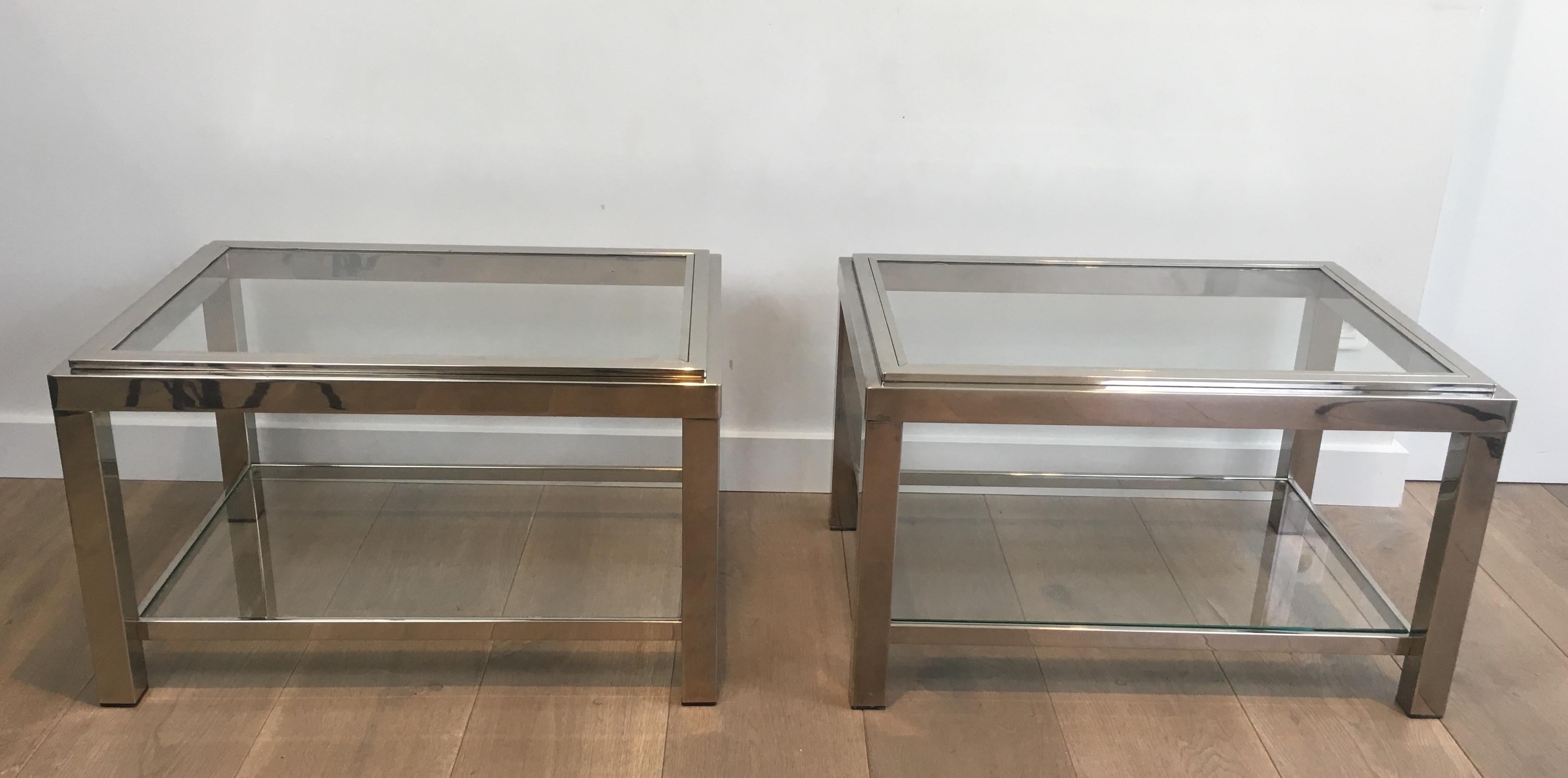 This pair of very nice rectangular side tables are made of chrome with glass shelves. The top glass frame is enframed into chromed elements. The quality of the tables is really good. This is a French work. circa 1970.