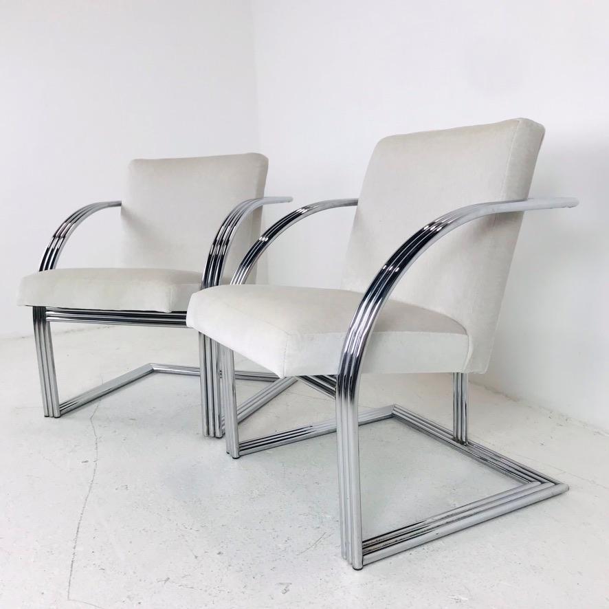 Set of 4 Milo Baughman cantilever chrome dining chairs. Curved chrome bar armrests with T-back.