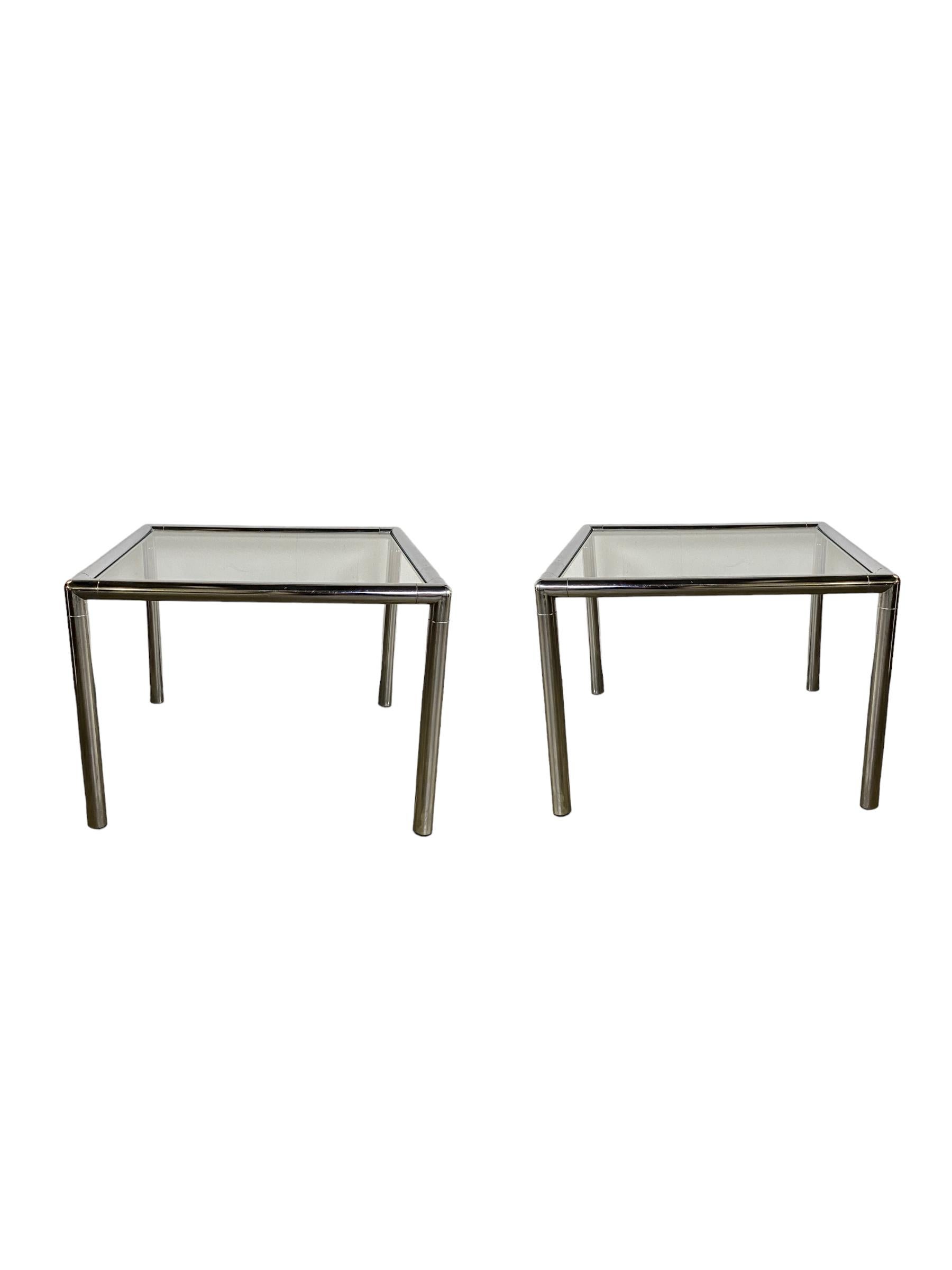 Pair of Chrome square end tables with clear glass insert. Chrome is in good condition, no pitting or rust. Glass is new and has no scratches or chips. Post mid century modern sleek design. Tubular chrome frame and glass table surface.
