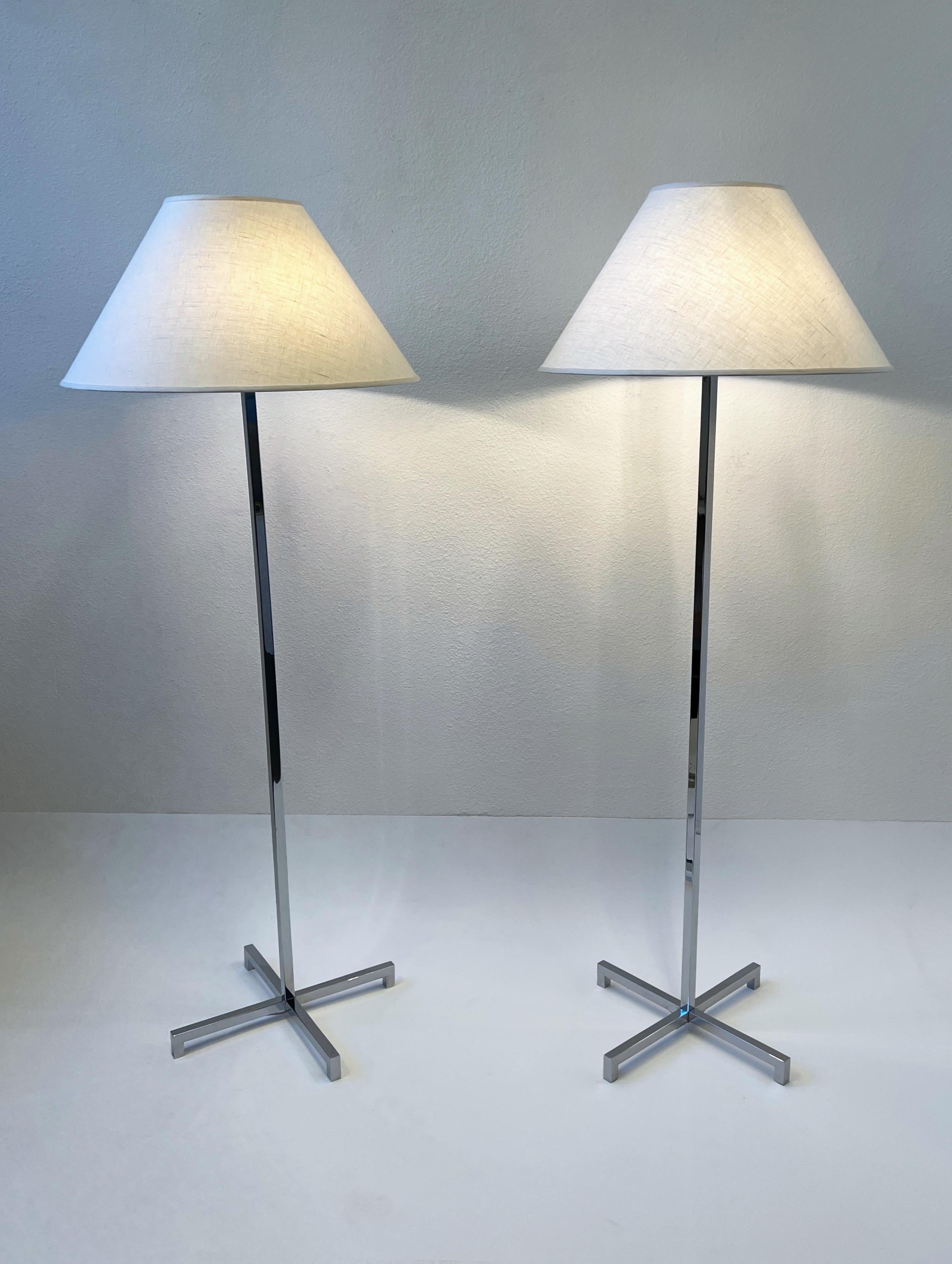 Glamorous pair of polish chrome floor lamps by renowned American designer T.H. Robsjohn Gibbings for Hansen Lighting Co.
Newly rewired and new vanilla linen shades. 
In beautiful vintage condition. 
Each lamp takes three 75w max Edison light bulbs.