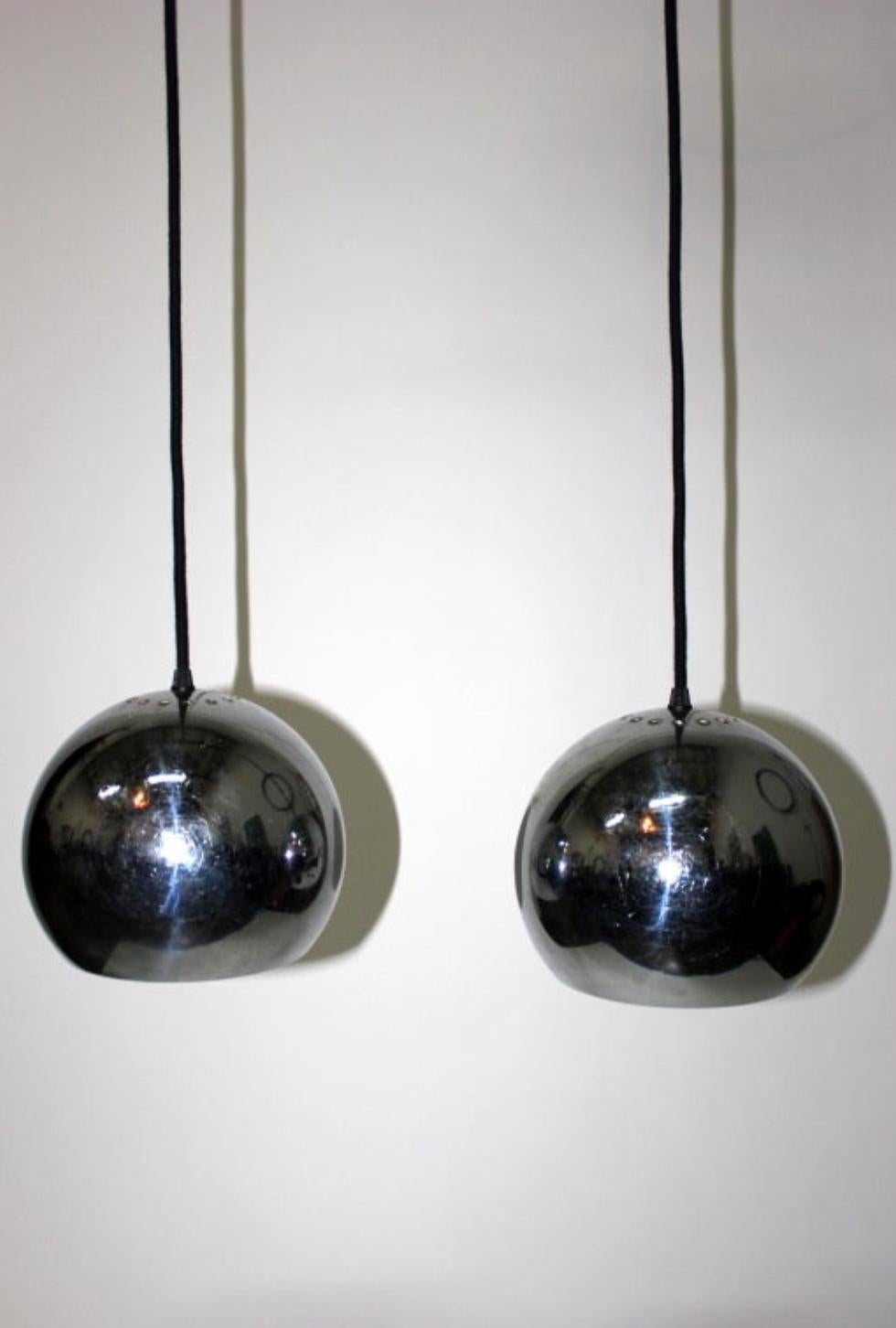 Pair of chromed globe French 60's lights. Current total drop: 69 in. (cord can be shortened). 9 in. diameter globes.