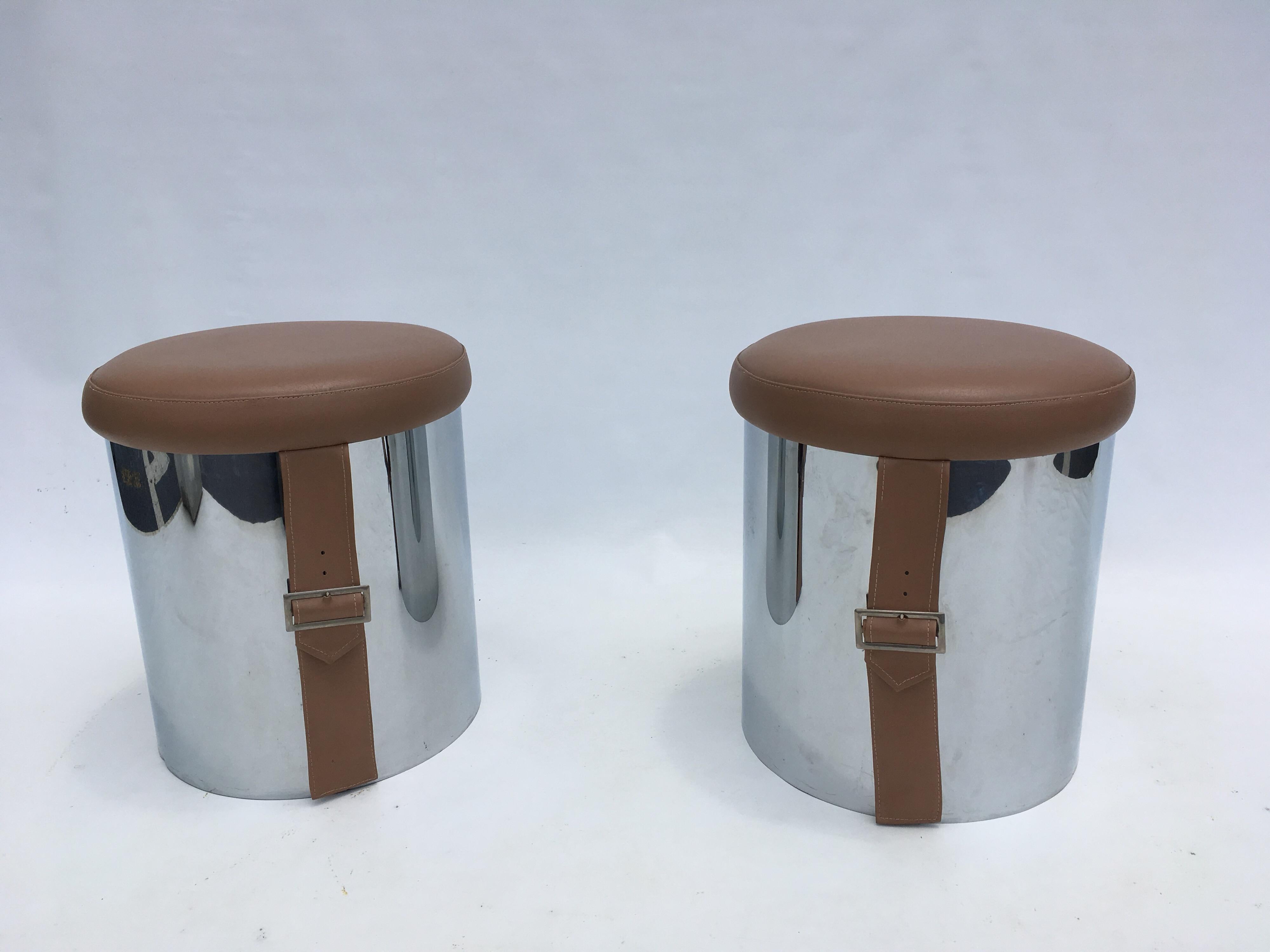 Chromed metal stools with vinyl seats.