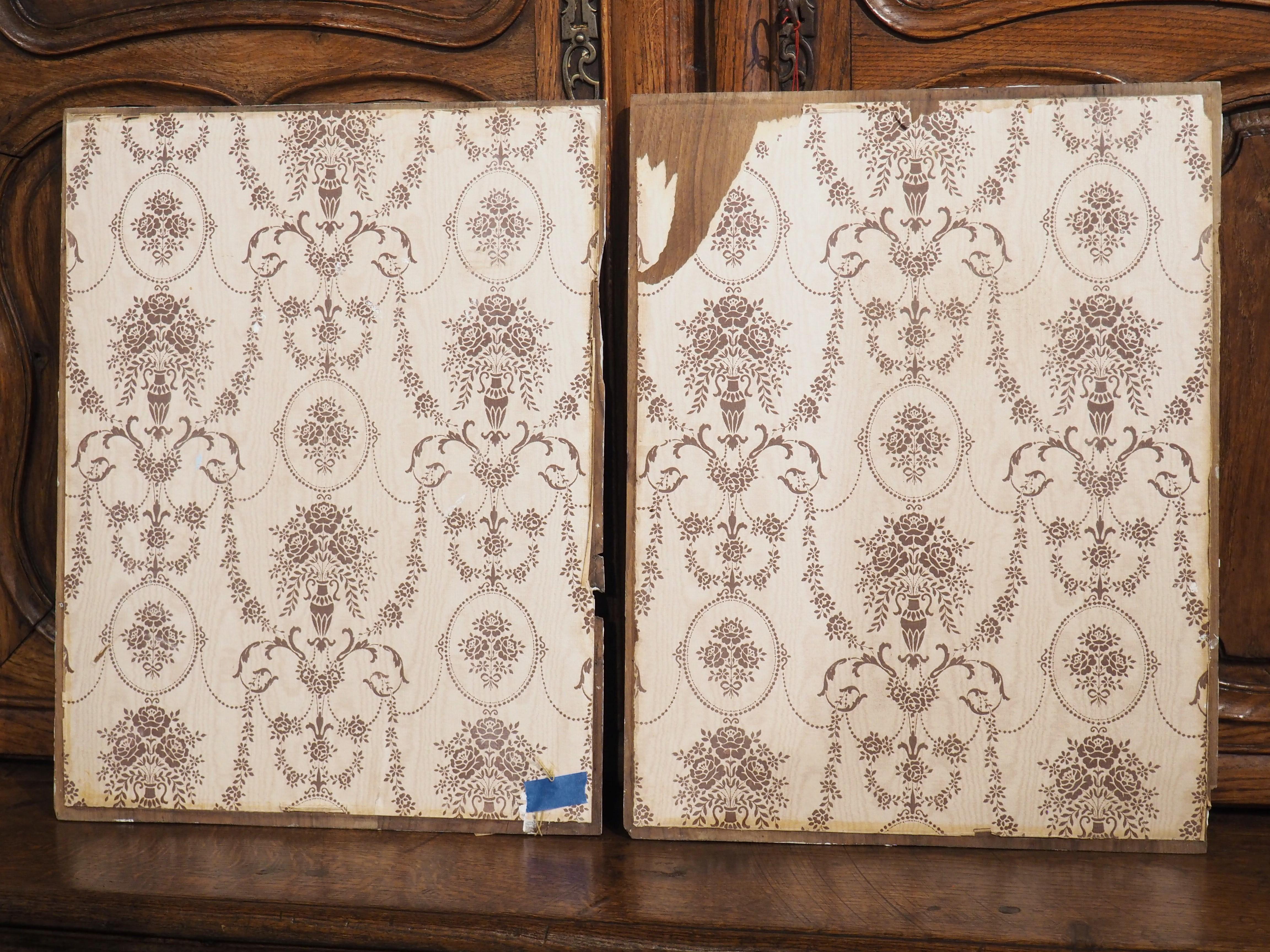 Hand-carved in Spain, circa 1850, this pair of walnut panels features portraits in profile of an armor-clad man and woman. Both panels have been painted light gray with cream accents, while the verso side is lined with cream-colored paper