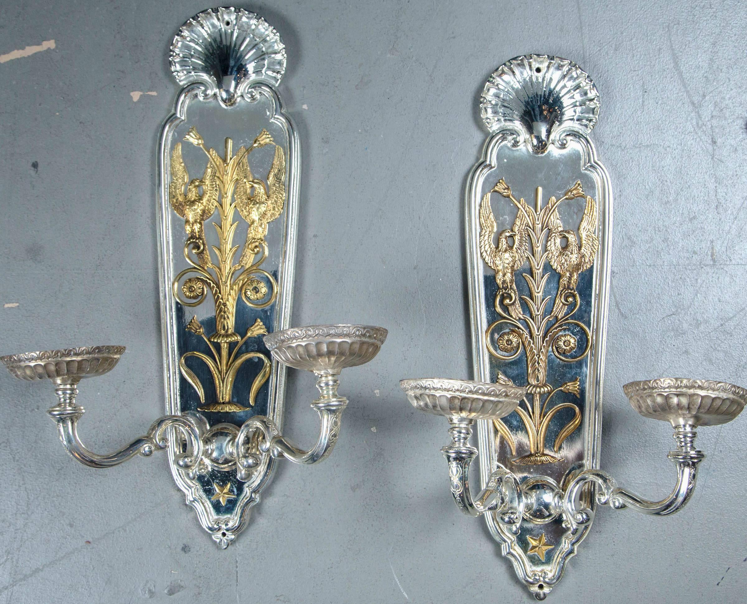 A pair of circa 1920 silver plated Caldwell sconces with gilt bronze design.