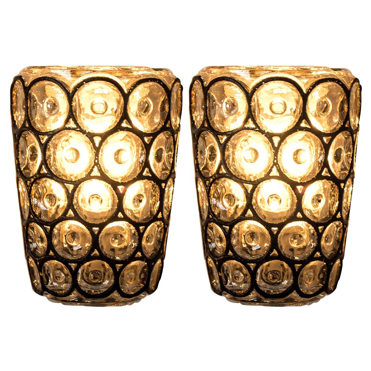 This beautiful and unique pair of hand blown glass wall lights were manufactured by Glashütte Limburg in Germany during the 1960s, (late 1960s or early 1970s). Beautiful craftsmanship. These midcentury vintage lights feature handmade heavy blown