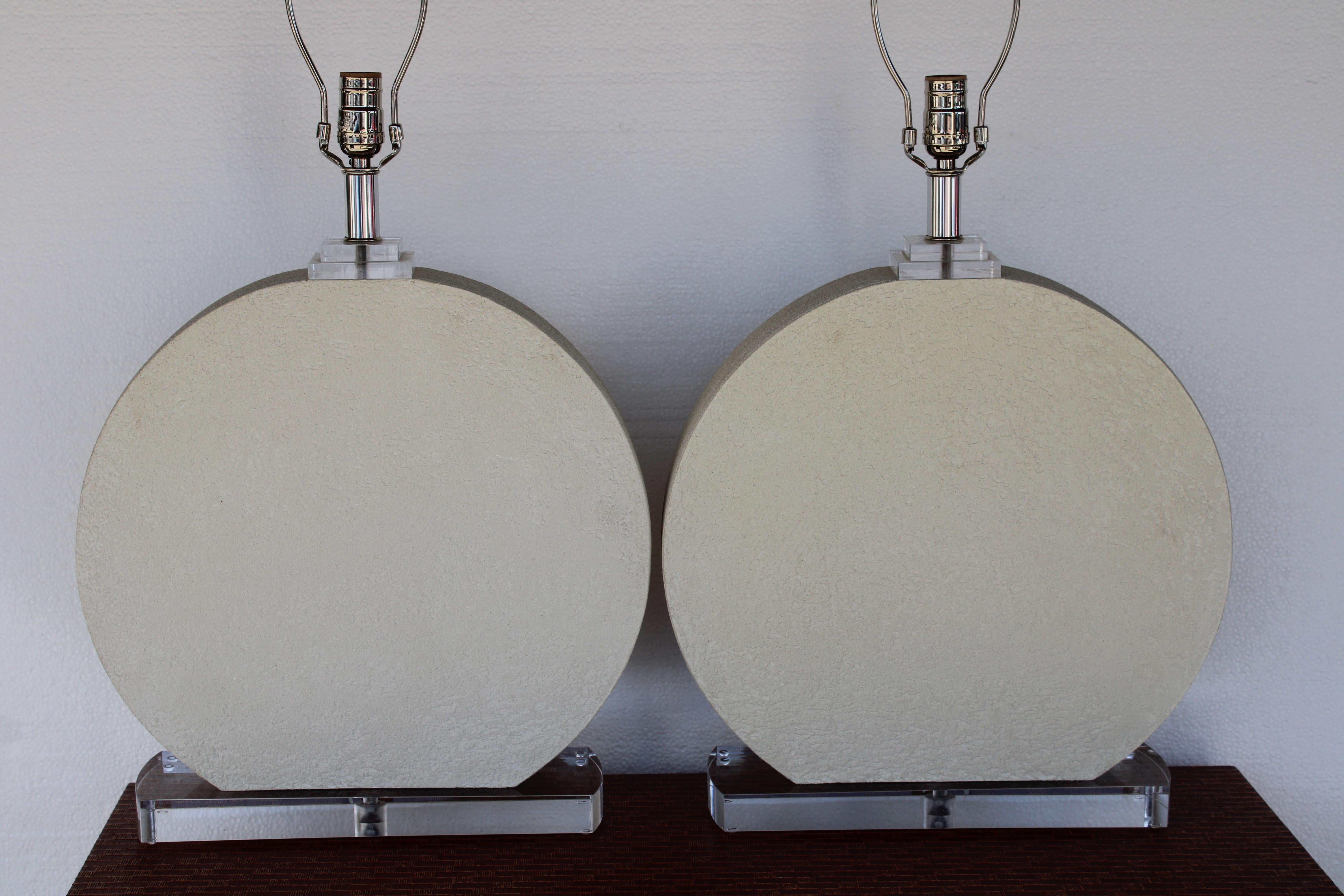 Pair of circular ceramic and lucite table lamps. Lamps measure 20.5