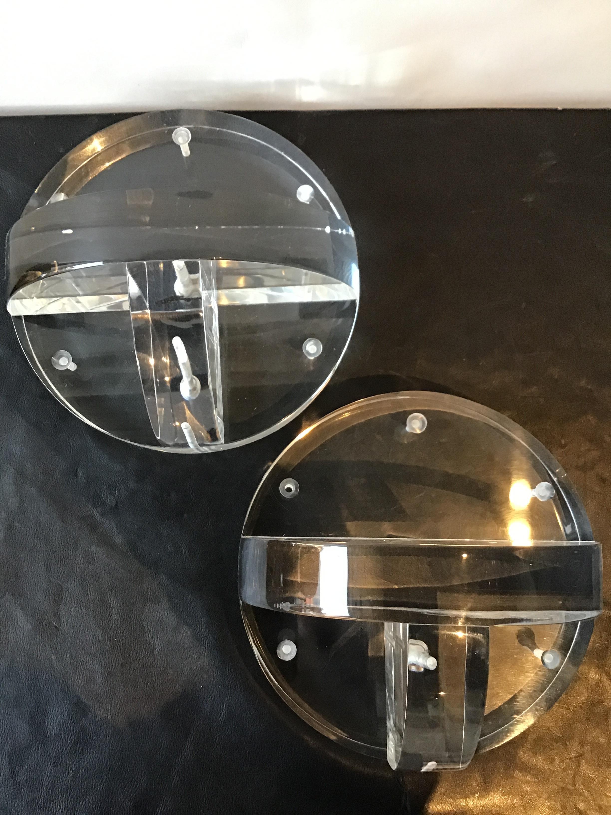 Pair of circular thick Lucite wall shelves.