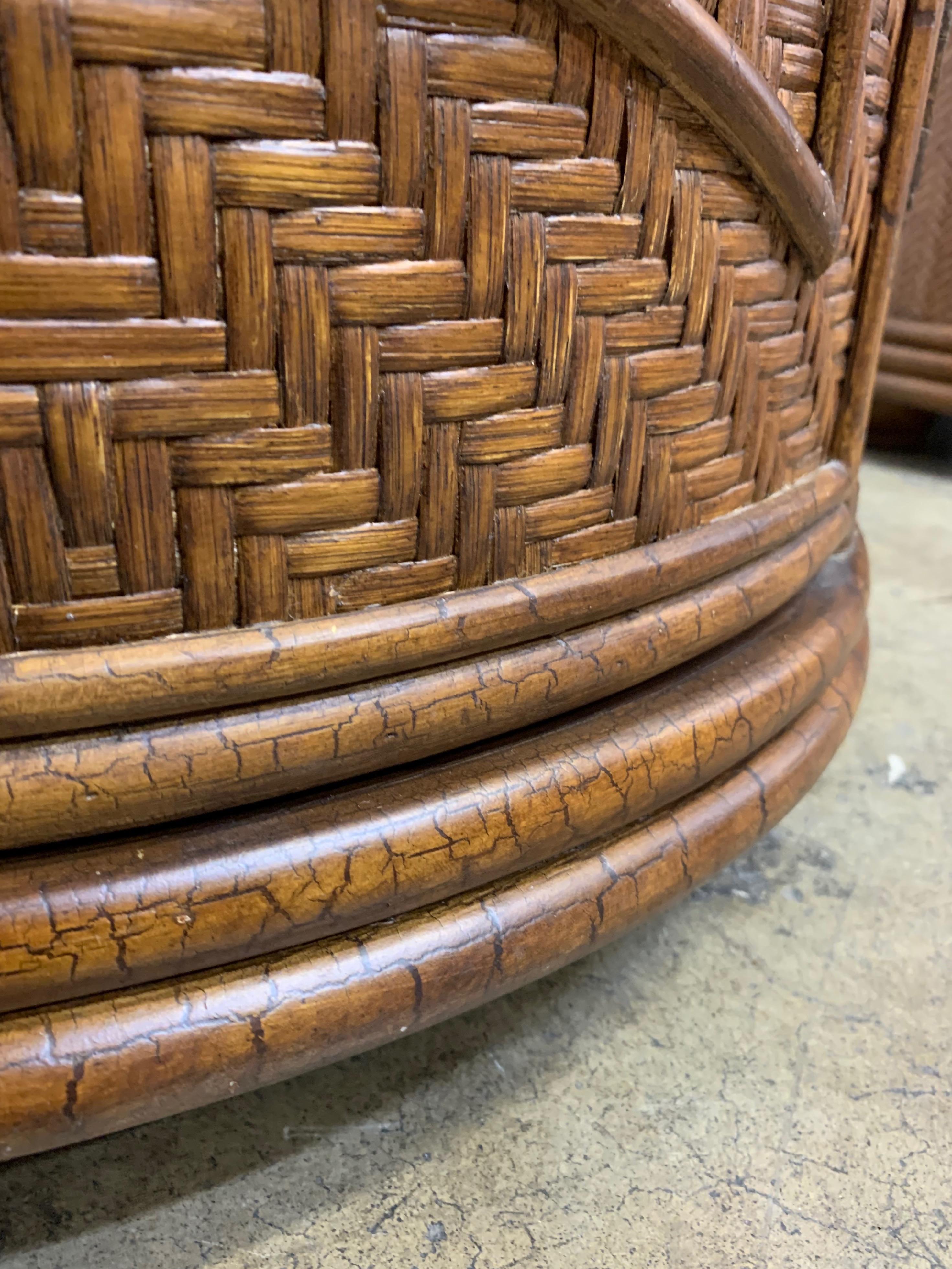 Faux distressed wood with cane woven in a chevron and diamond pattern.
Both cabinets are topped with chocolate travertine and have a single door with metal pull for storage.