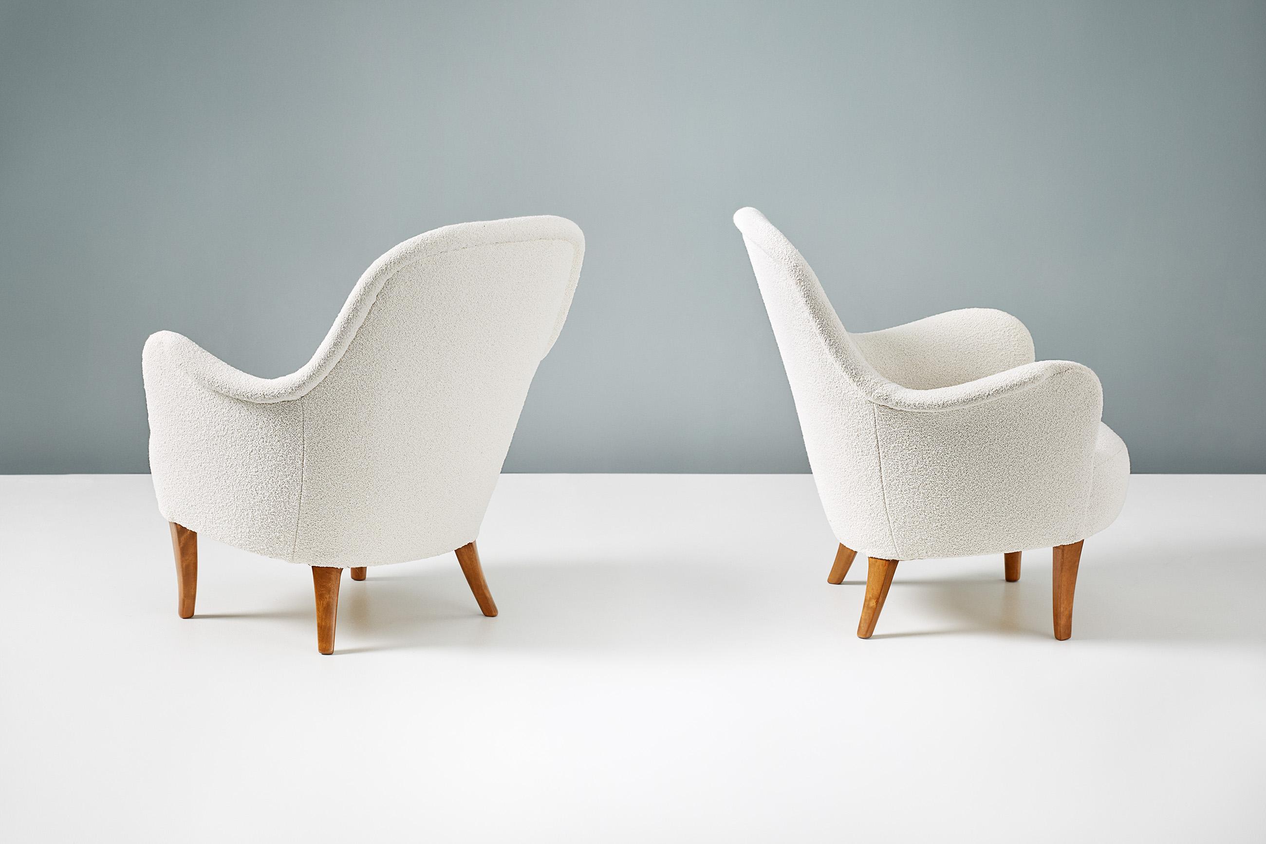 A pair of armchairs designed by Carl Malmsten in 1950s and produced in Sweden. This pair have been reupholstered in chase Erwin 'Embrace Cotton White', a luxurious off-white wool-cotton blend fabric. The legs are stained elm wood.

  