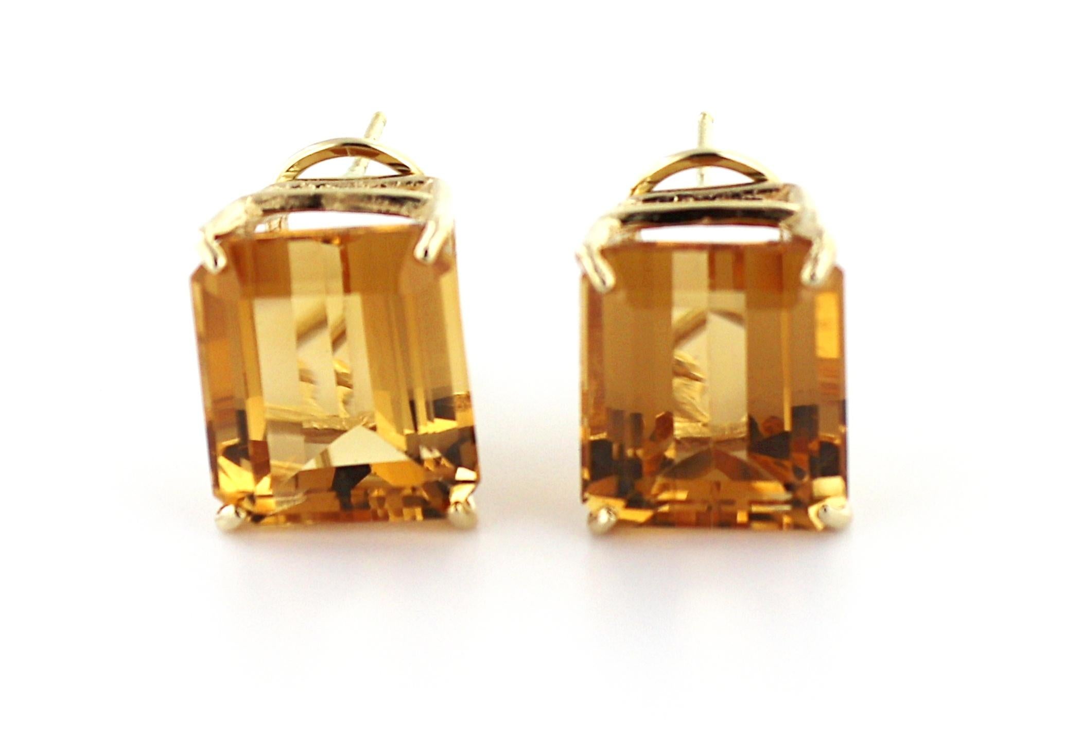 Featuring (2) emerald-cut citrines, 16.70 cts., set in 14k yellow gold, hinged omega back mountings, 14.5
X 12.1 X 18.1 mm, Gross weight 8.72 grams.