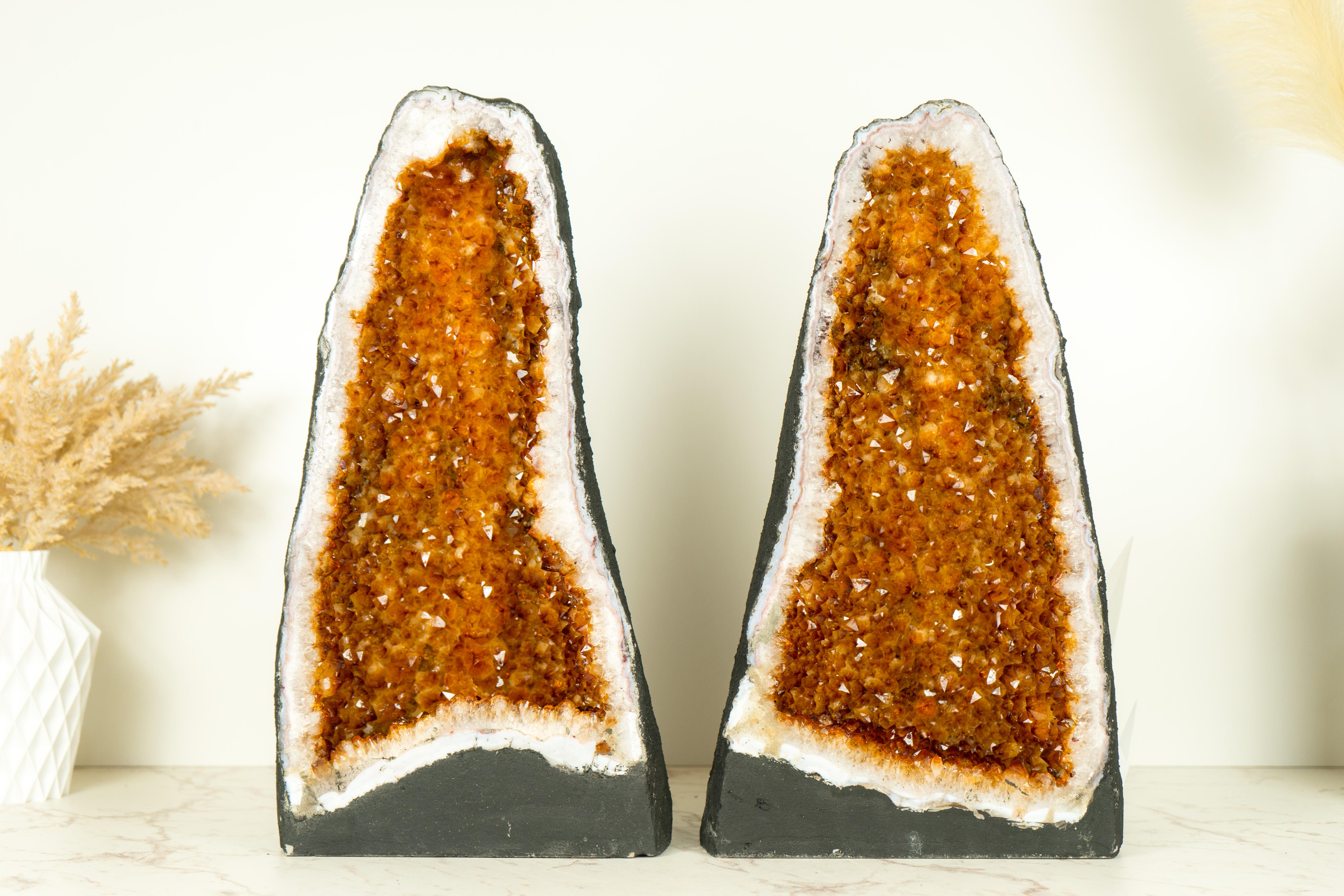 With its perfectly formed Geode Cathedral format and shimmering AAA-grade orange citrine druzy, this pair of Citrine Geodes will undoubtedly elevate the aesthetic of any environment, whether as a centerpiece in your collection or a captivating focal