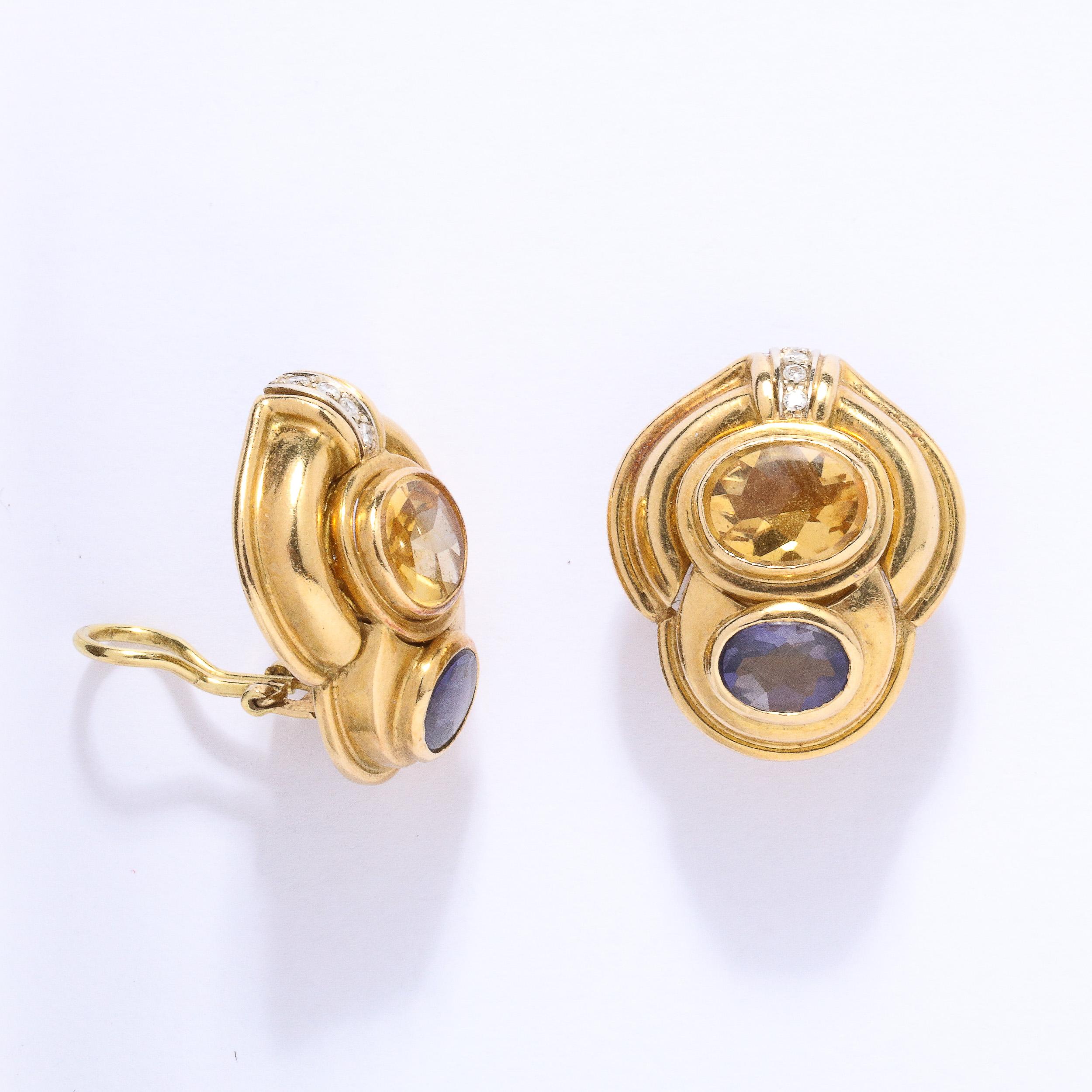 These gorgeous clip on earrings are set with an oval cut citrine and an oval cut Iolite surrounded  in a 18k gold stylized tiered  design which is also set with 4 round diamonds in each. They are marked 18k Italy and the purchaser could easily have