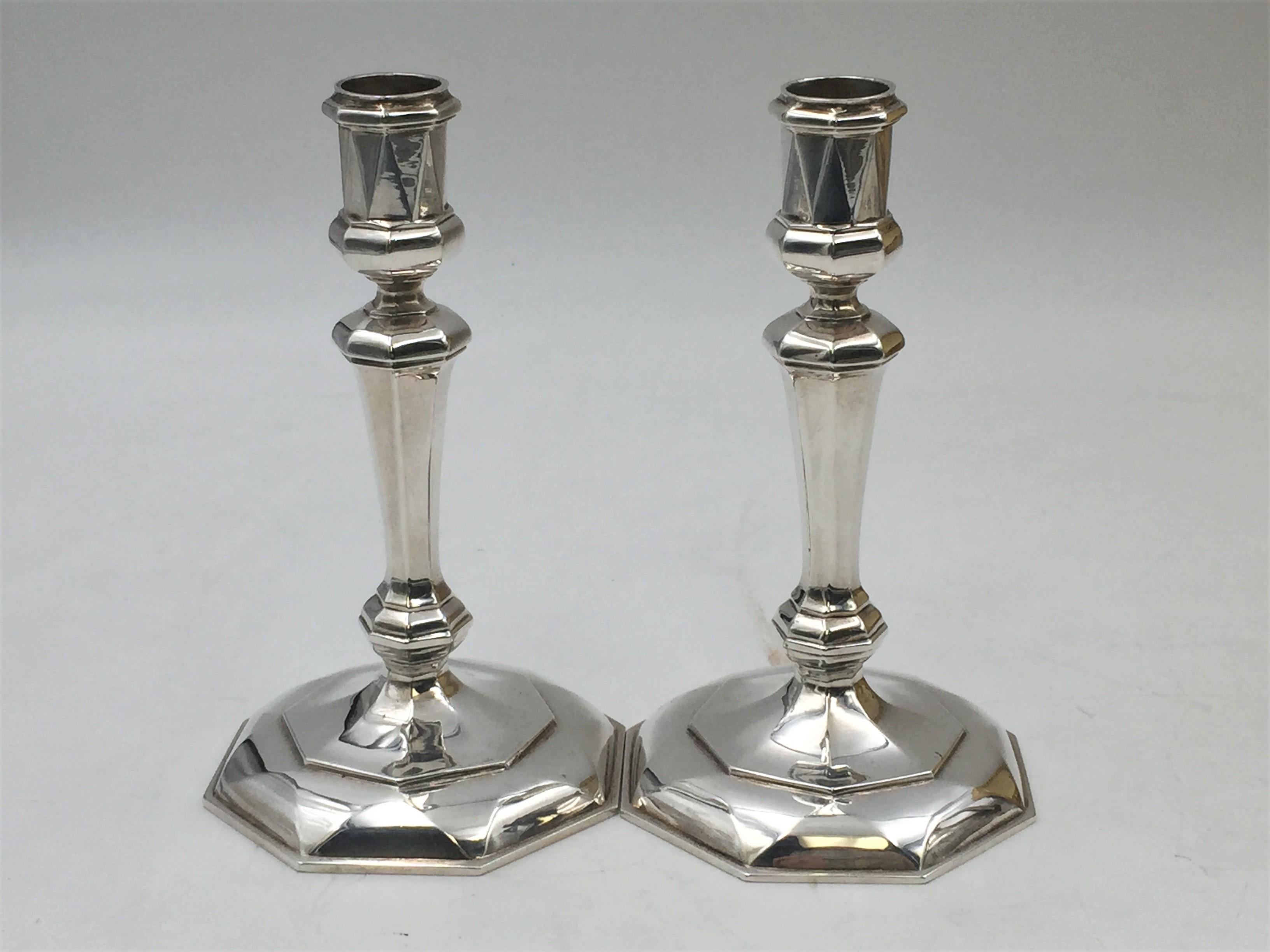 Pair of multi-faceted English cast silver tapersticks/ candlesticks, by illustrious designer CJ Vander in the Queen Anne style and from 1970. Measuring 5.7” tall and 3.3” wide at base. Weighing 13.2 troy ounces. Bearing hallmarks as shown.

The