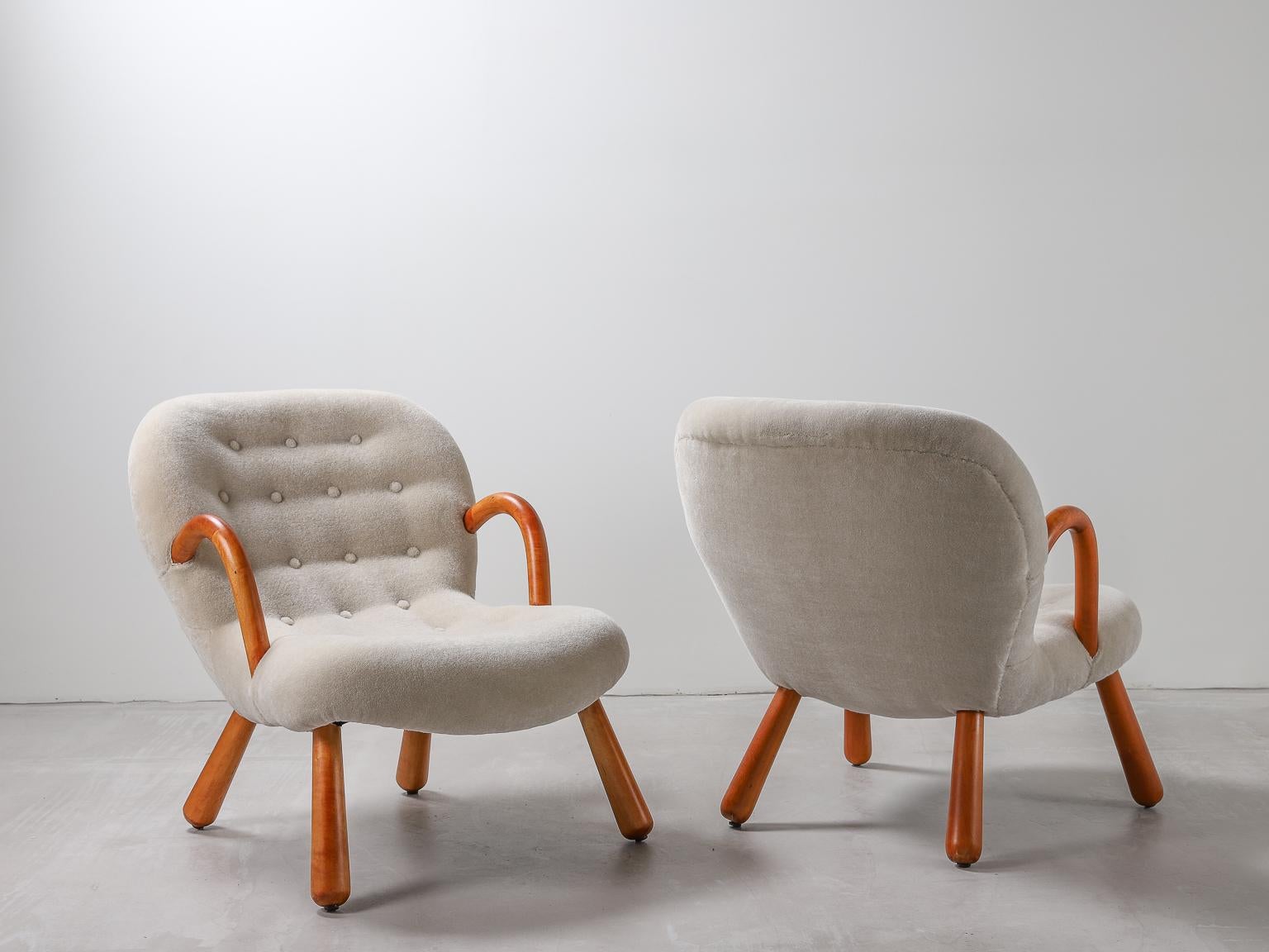 A pair of original 'clam' (Muslinge-stolen) armchairs designed by Philip Arctander, newly re-upholstered in bespoke mohair velvet fabric. The beech Lightly restored Beech wood bearing patina. 

Danish architect Philip Arctander (1916-1994) who's