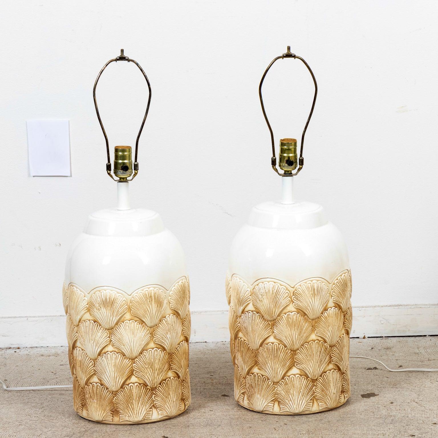 Pair of white painted table lamps with layered clam shells motifs and metal hardware. Please note of wear consistent with age including minor chips and finish loss. Shades not included.
  
