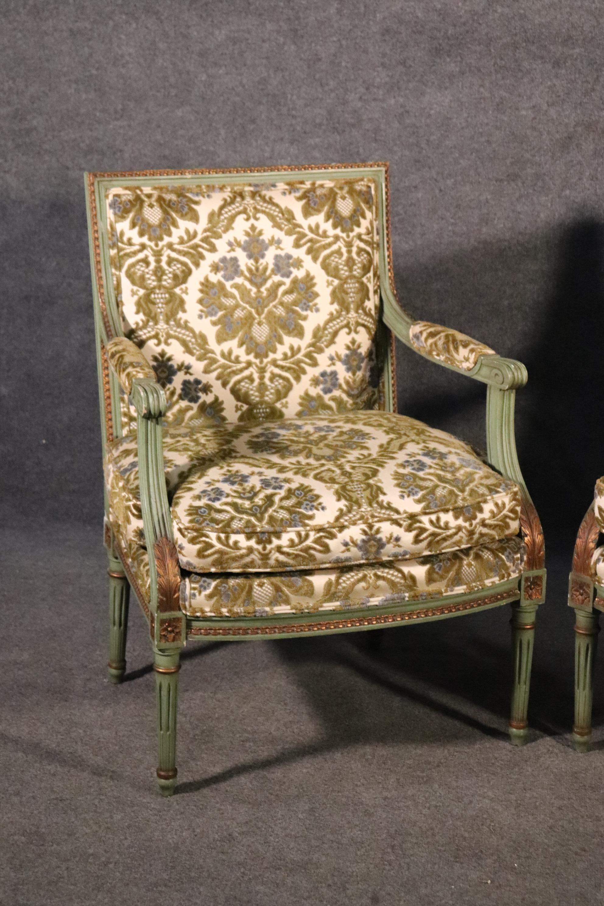 This is a classic square back pair of bergere chairs in their original finish and upholstery. The chairs are in good condition but the cushion foam will need to be redone as they are old and no longer soft. The chairs measure 35 tall x 25 wide x 24
