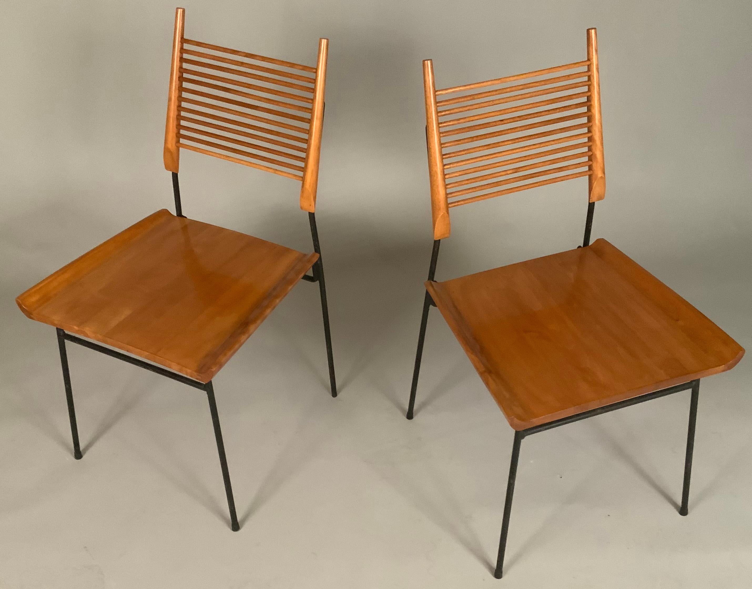 a rare pair of classic 1950's 'Shovel' chairs by Paul McCobb. one of his most sought after chairs, the shovel chair has a spare and elegant wrought iron frame, with scooped 'shovel' seats in solid maple, and solid maple ladder backs.
 