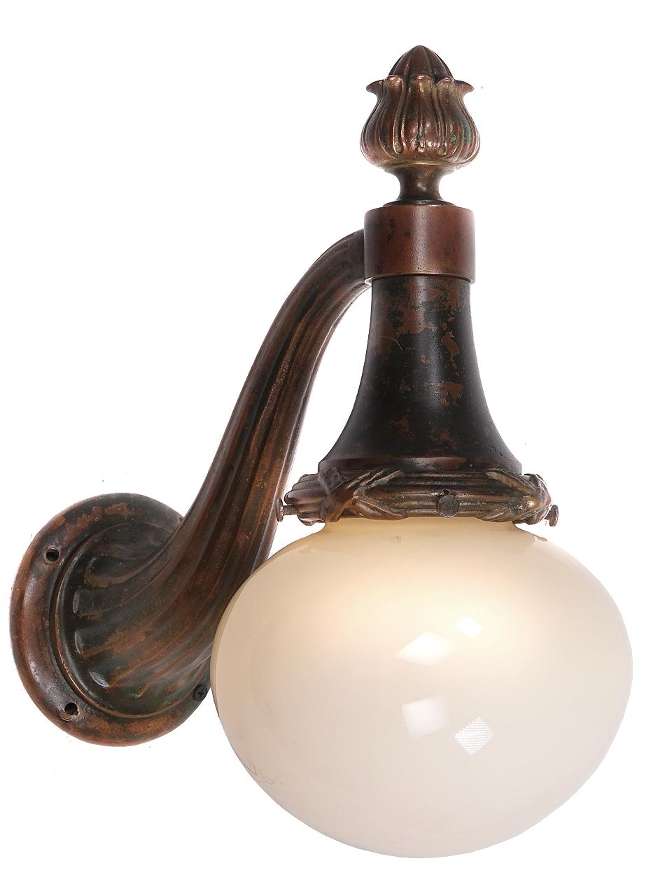 This is an early matching pair of heavy bronze torch style sconces.
The finish is untouched and has a beautiful patna. The globes are translucent vaseline over milk glass. The shape of the globe a flattened oval with a 6 inch diameter.