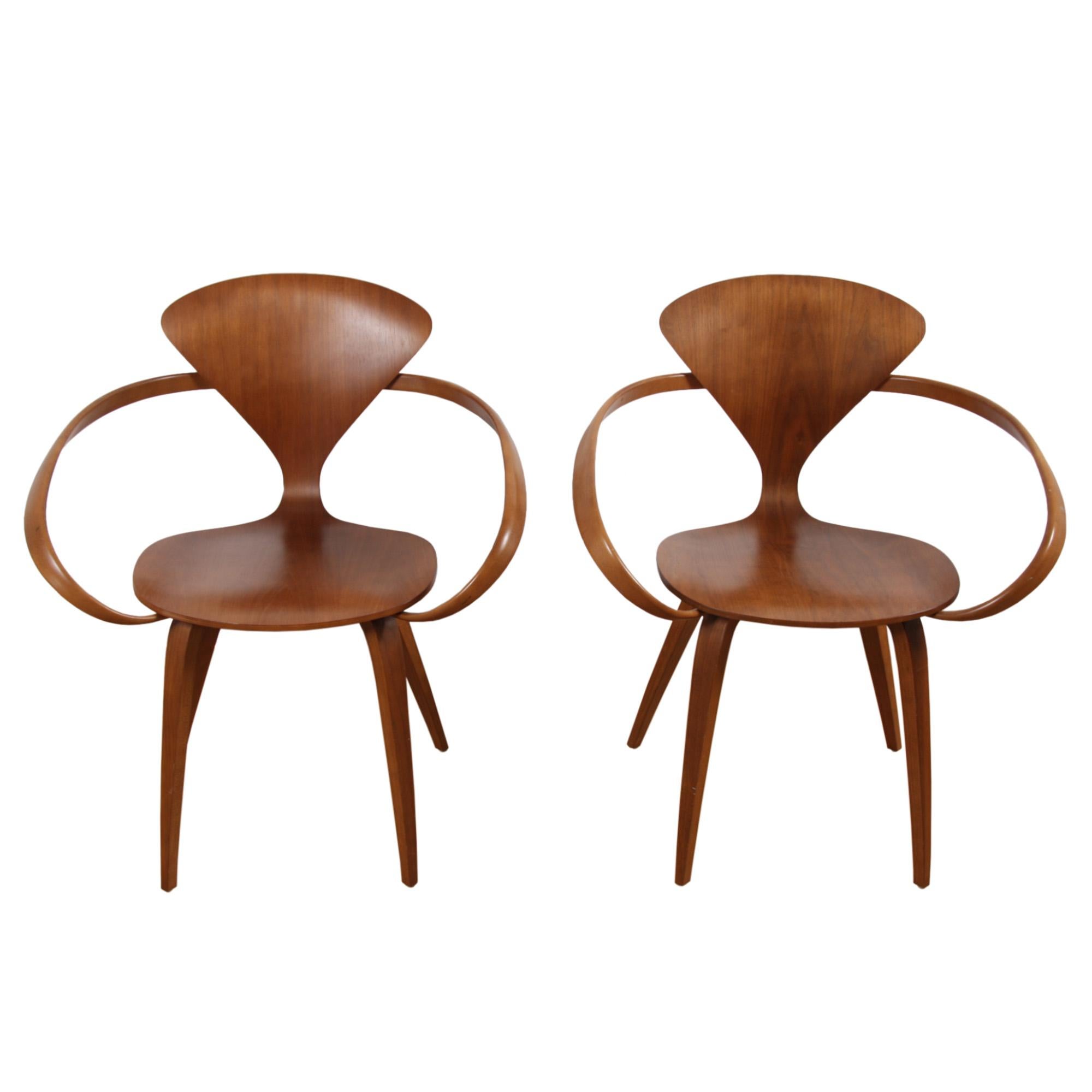 This is a pair of walnut veneered plywood chairs made by the Cherner Chair Company in the United States. A classic modern design, featuring the 'wasp waist' silhouette.

Norman Cherner is considered a hero of modern design. He studied and lectured