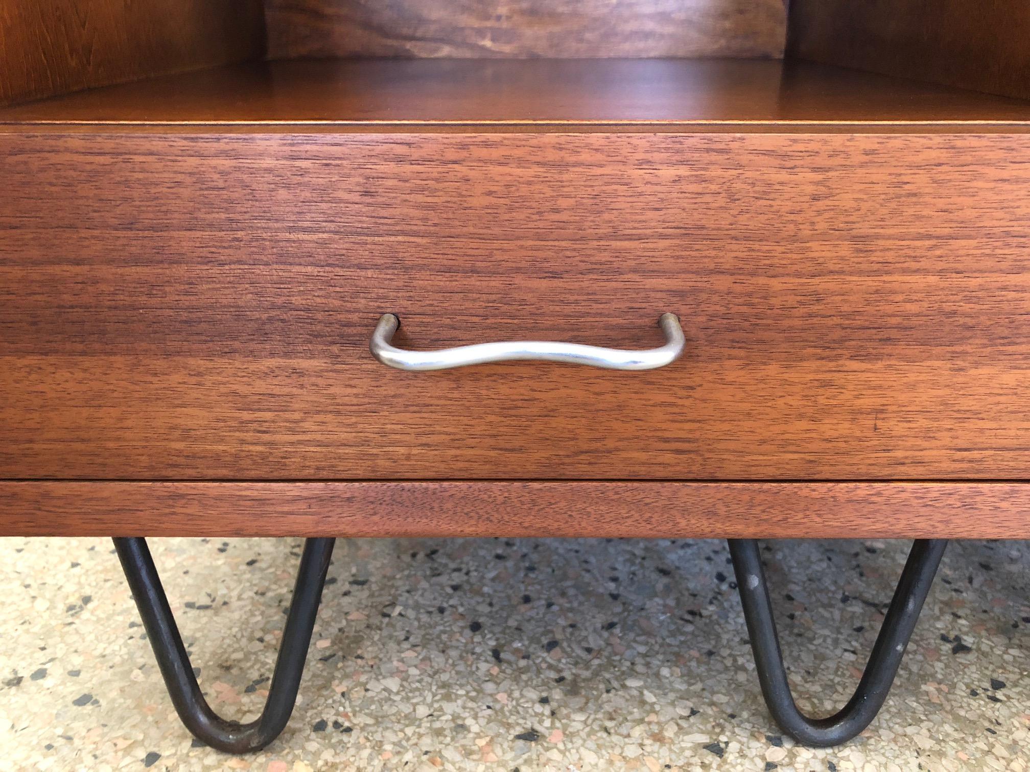 A pair of classic George Nelson for Herman Miller nightstands with hairpin legs.