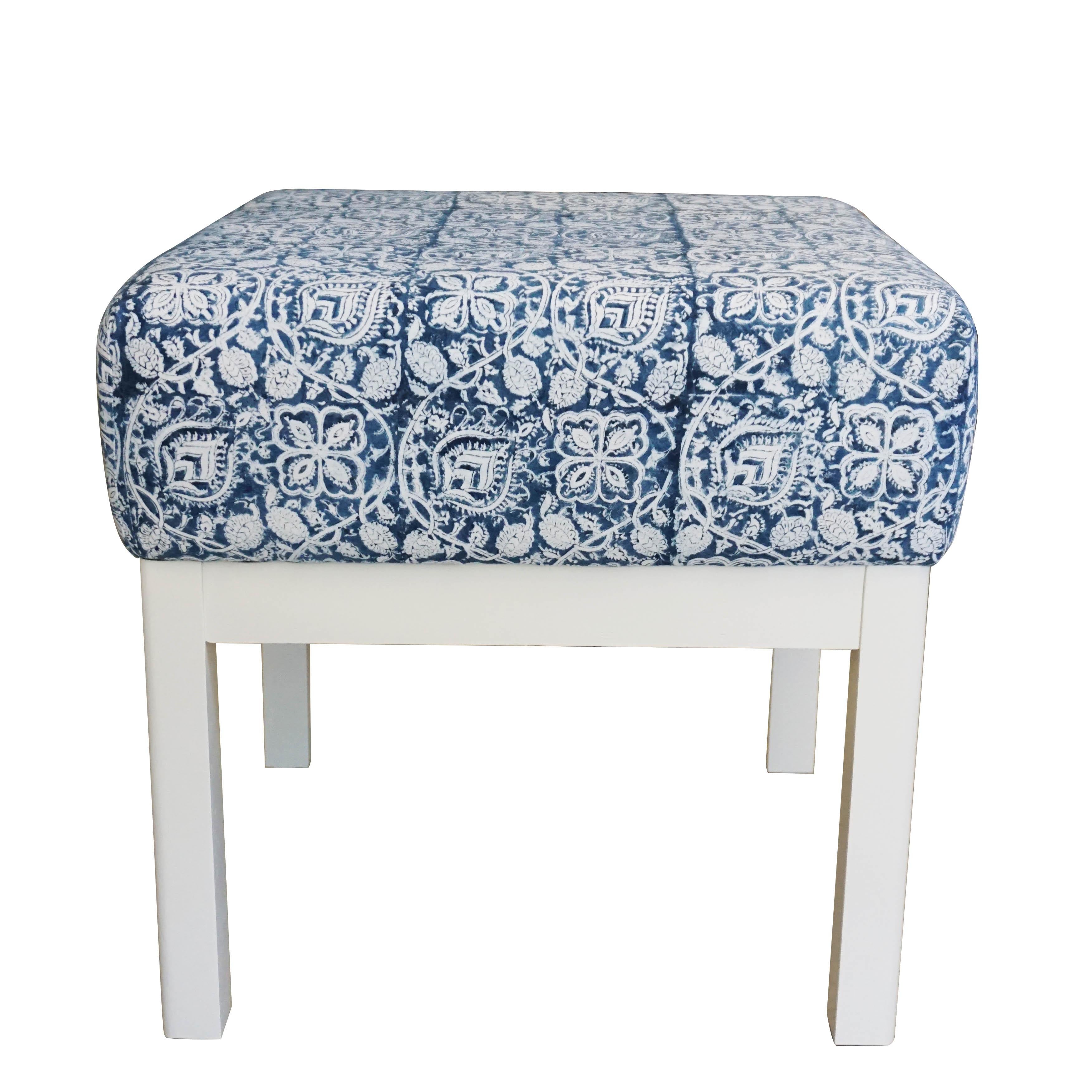 A pair of Classic square low stools with cushions upholstered in hand block printed fabric. This particular print was manufactured for Ralph Lauren and is of high quality. The solid wooden frames have been refinished in satin finish dove white.