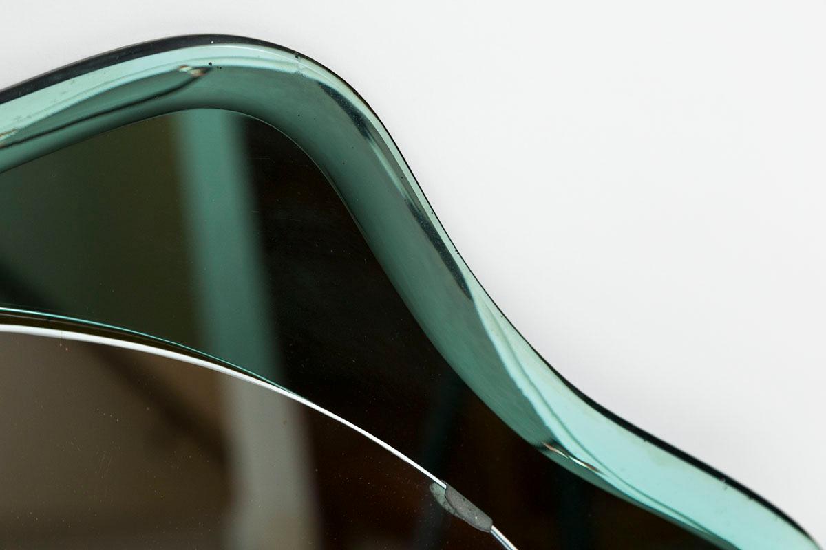 Encantador espejo de mediados de siglo con un marco de cristal festoneado verde Fontana biselado de gran belleza, que se muestra con un cristal original ahumado de aspecto verde claro.

Origen: Italia

Fechado: 1960ca

Dimensiones: 31,5″ de
