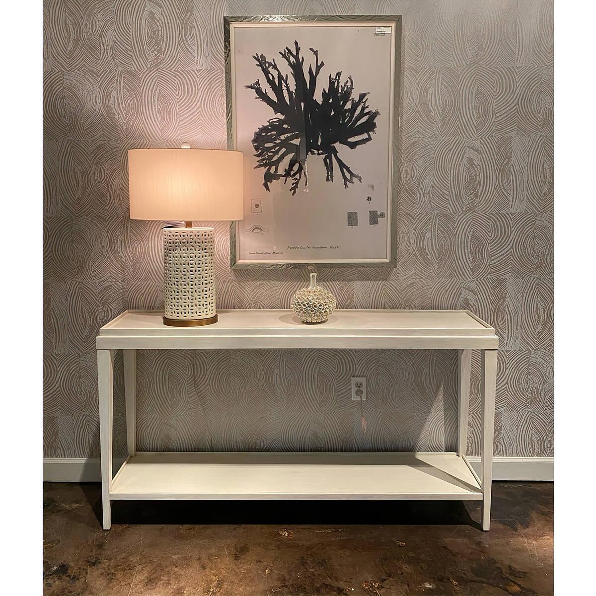 A Classic rustic console table with a 'drift' white painted finish with subtle grey distressing, with a wooden galleried dish top, square tapered legs and a shelf stretcher.

Dimension: 62