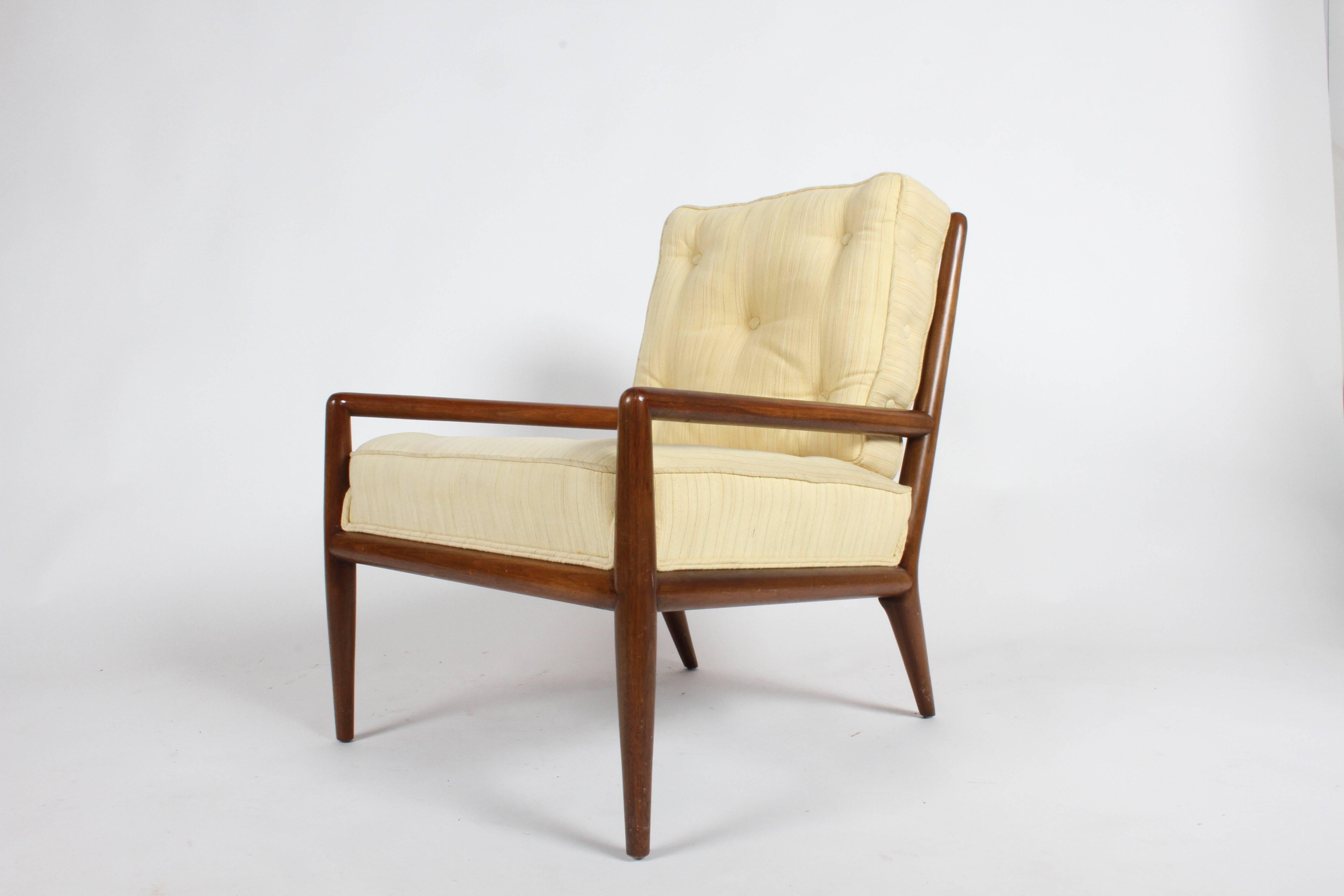Pair of elegant T.H. Robsjohn-Gibbings for Widdicomb lounge chairs. Walnut frames with original upholstery, note that attached seat cushion is thicker and proper tufting and buttons on side of back cushion as Gibbings originally designed for the