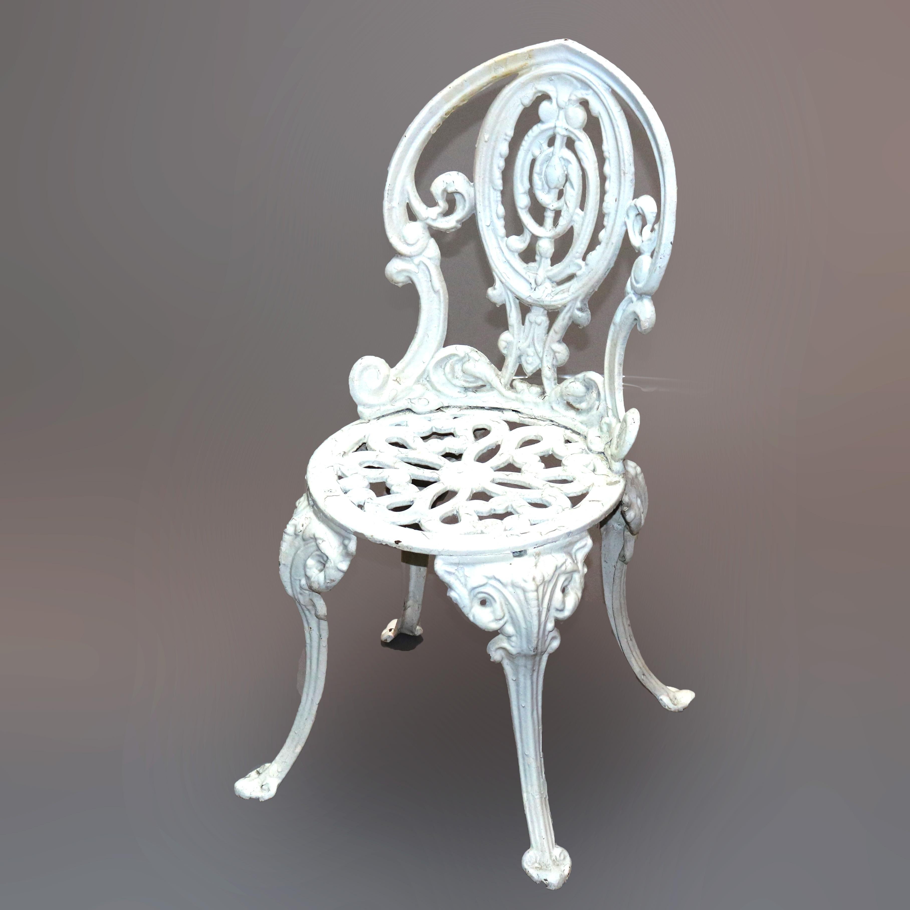 A pair of Classical garden chairs offer painted cast iron construction with foliate form frame having medallion back and raised on cabriole legs, 20th century

Measures: 28