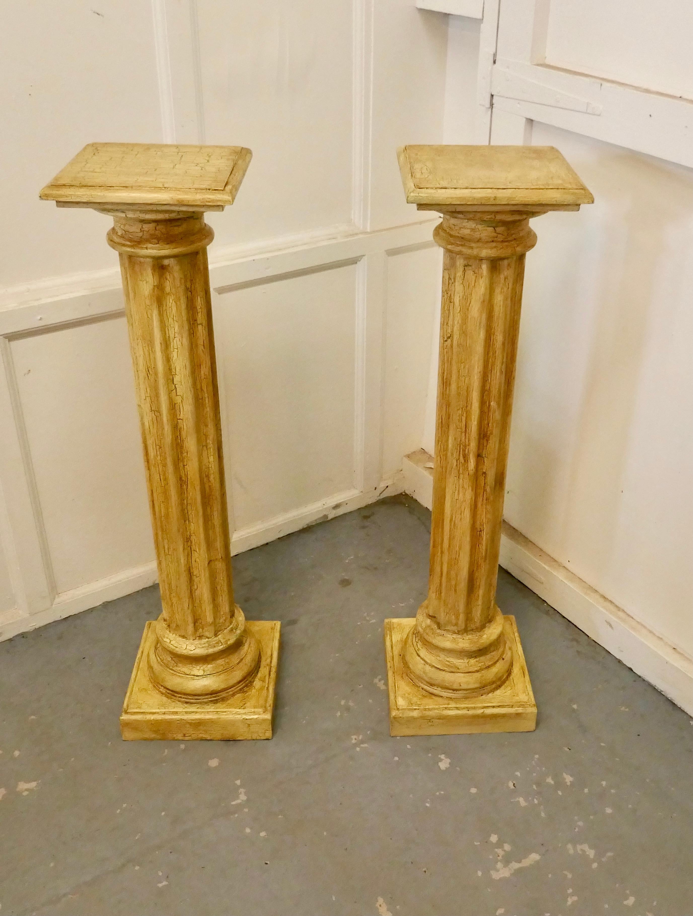 Pair of Classical column pedestals in distressed crackle finish paint.

A superb pair of fluted classical column pedestals, the pedestals are made in wood and painted in a dark Cream crackle finish 


The columns are 42” tall and 12” square on