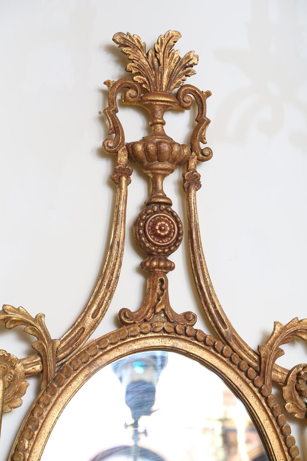 Neoclassical Pair of Classical-form Italian Carved Giltwood Oval Mirrors