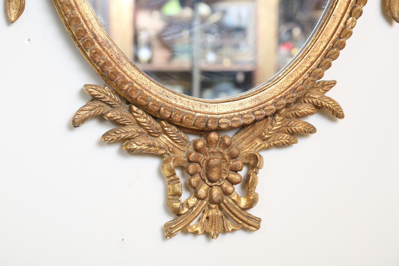 Hand-Carved Pair of Classical-form Italian Carved Giltwood Oval Mirrors