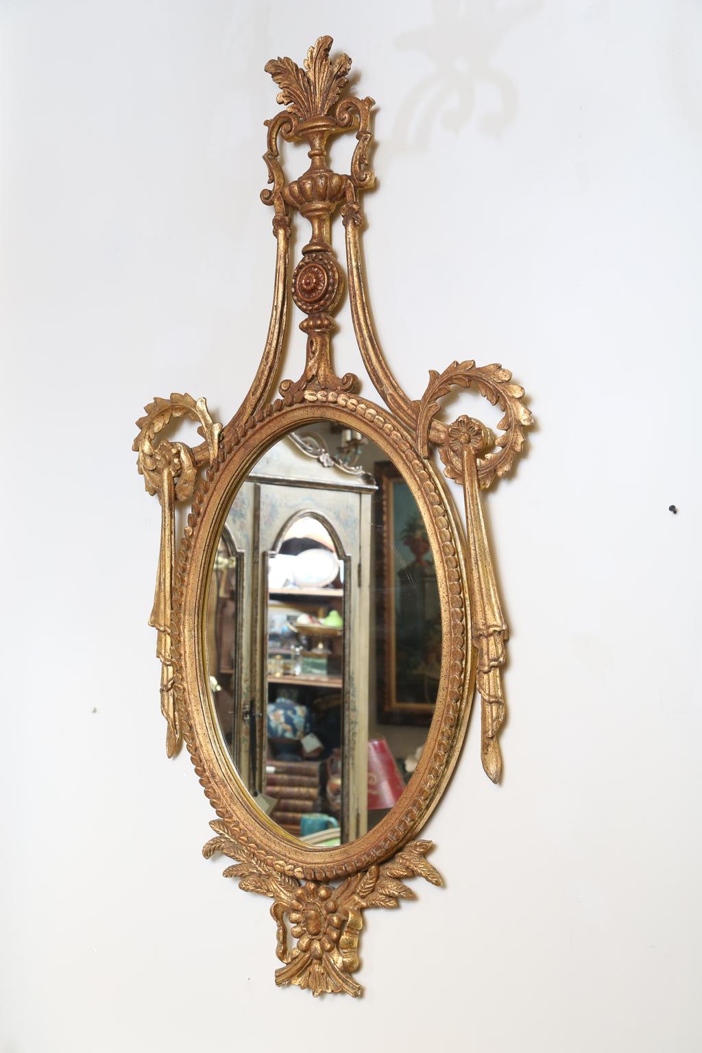 Mid-20th Century Pair of Classical-form Italian Carved Giltwood Oval Mirrors