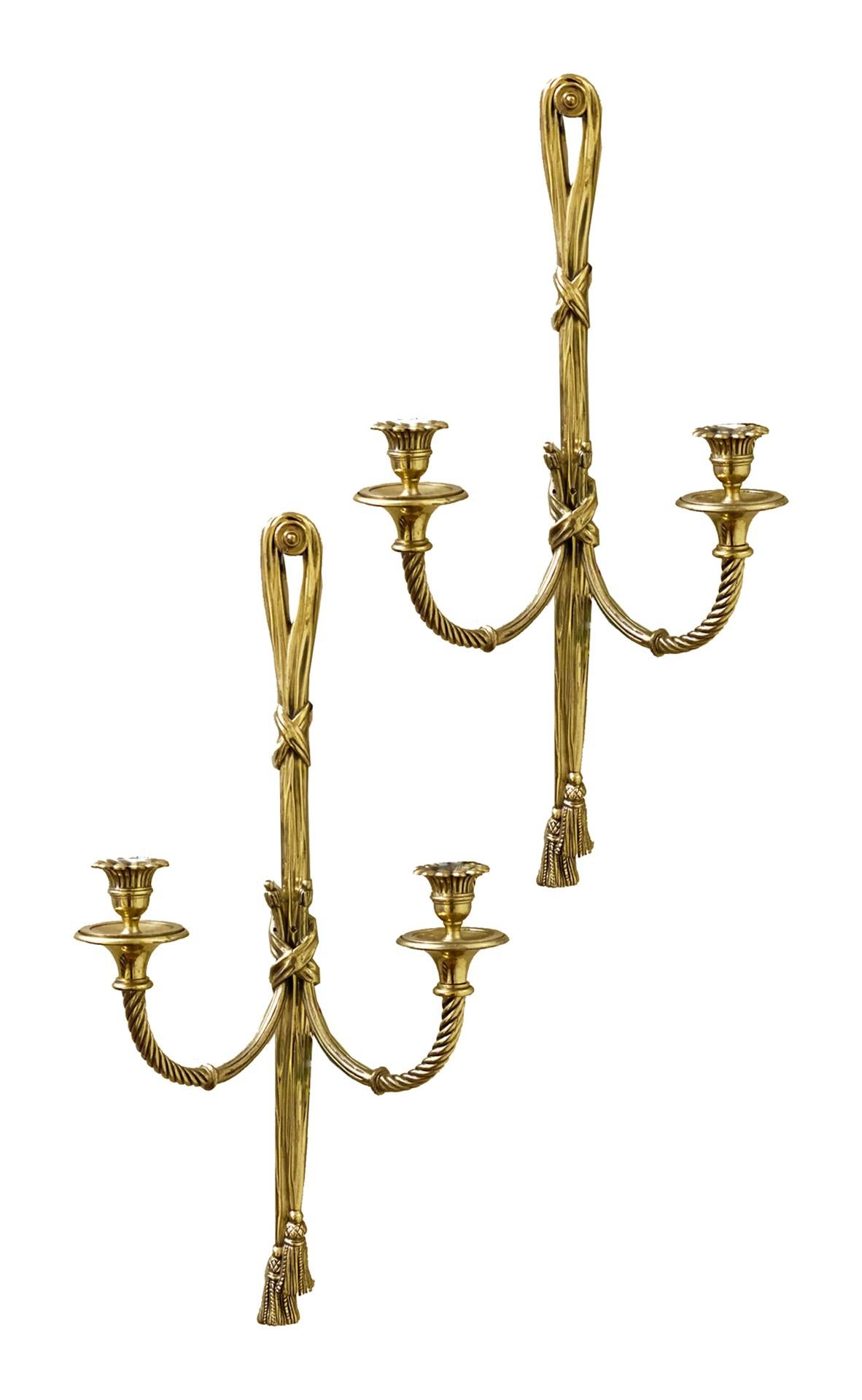  Pair of classical French ormolu Louis XVI style two branch wall lights each with ribbon and tassel decoration, circa 1900.

