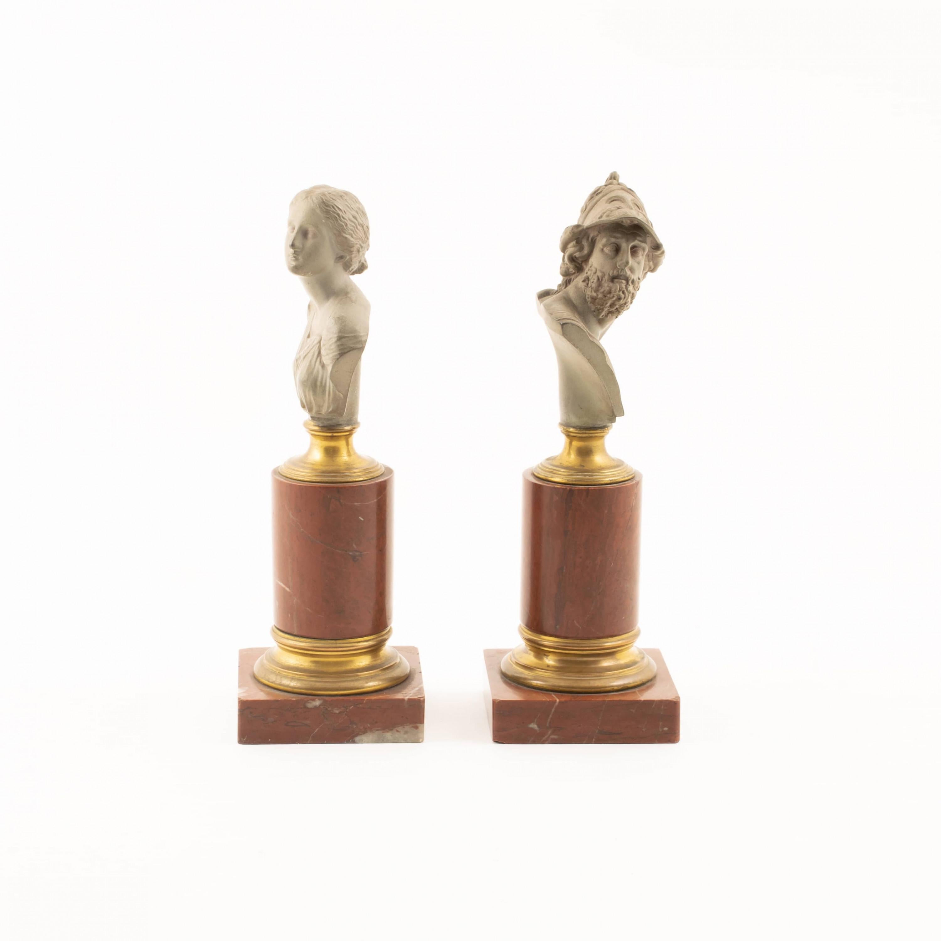A pair of classical Greek figure busts, 21 cm high.
King Menelaus of Sparta and his wife Helena.
Cast metal on bronze columns gilt in reddish marble.

Made at H. Gladenbeck & Sohn 1860s, art foundry in Berlin 1851 - 1926.
Especially known for