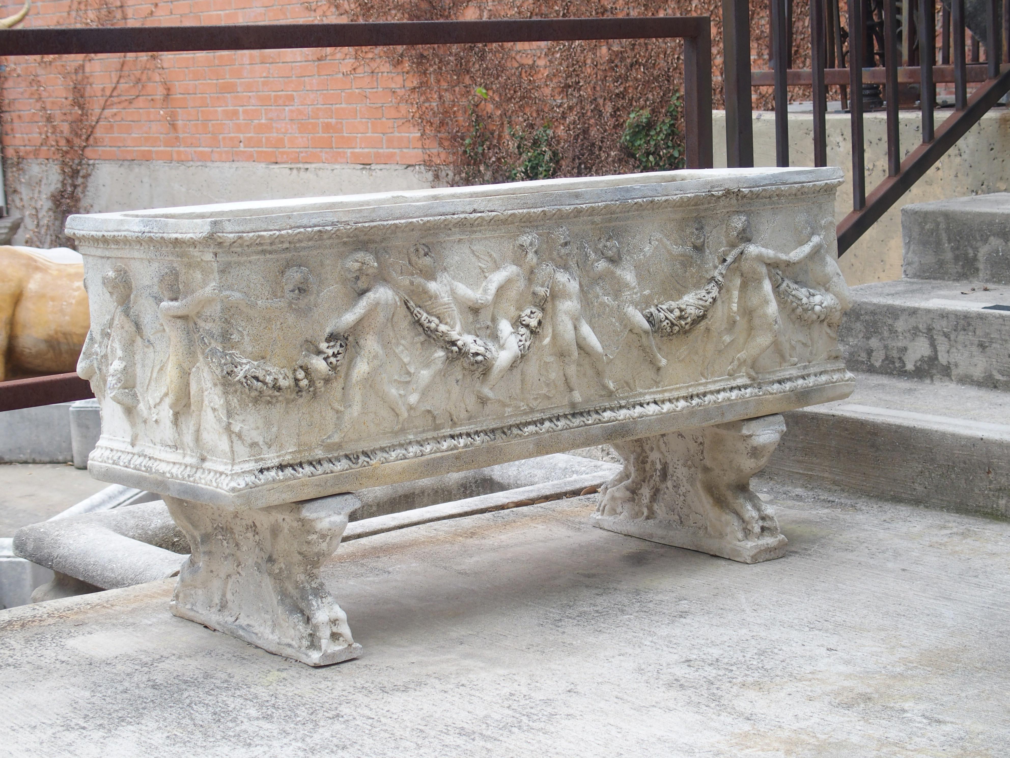 After a 19th century original by Manifattura di Signa, this pair of garden planters or troughs has a Bacchanalian scene set between two layers of foliate embellished moldings. Manifattura di Signa was an Italian workshop that specialized in terra
