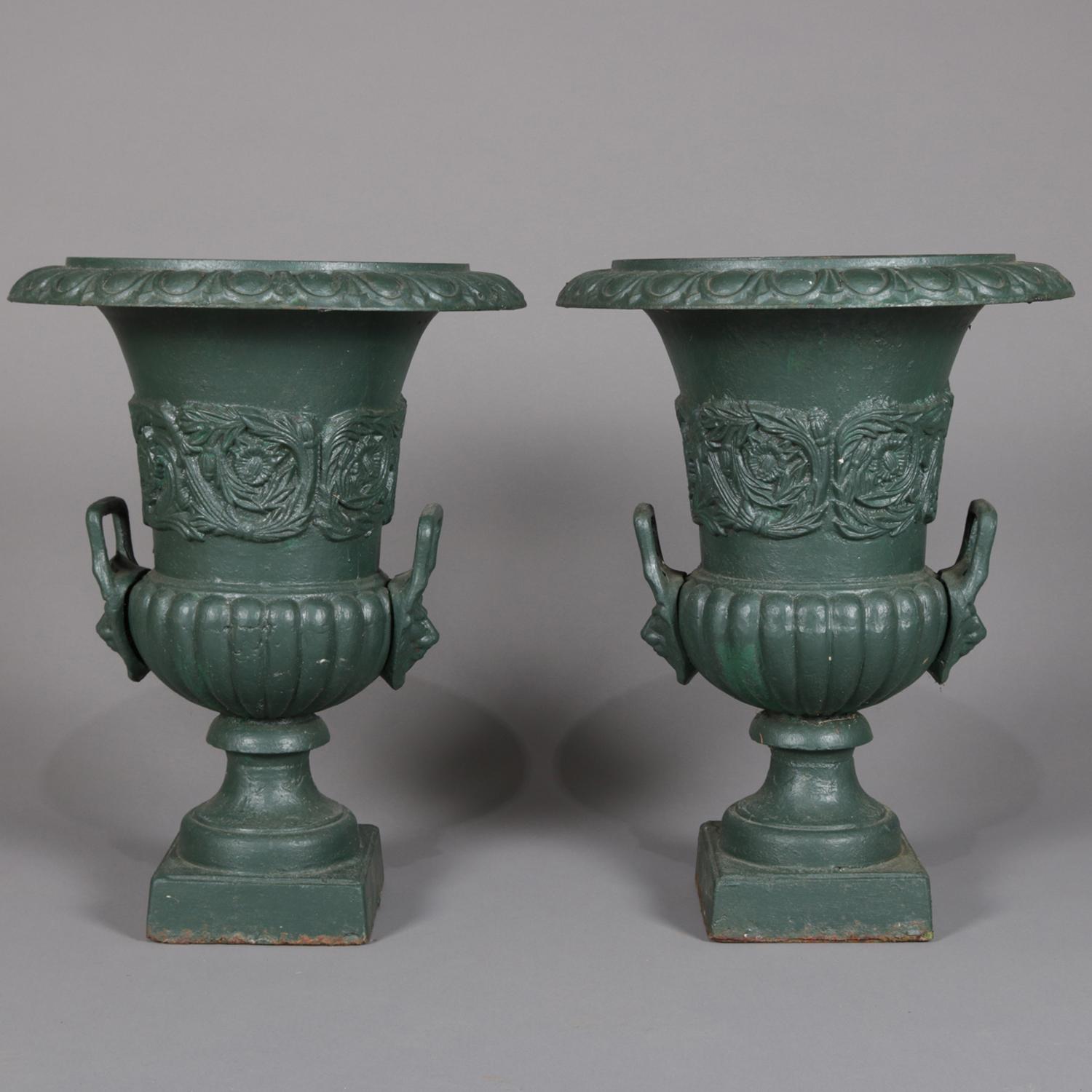 A pair of well cast Classical garden planters feature iron construction in pedestal urn form having double handles, reeded bowl bases and bands of high relief foliate decoration, painted green, 20th century

Measures: 24.5