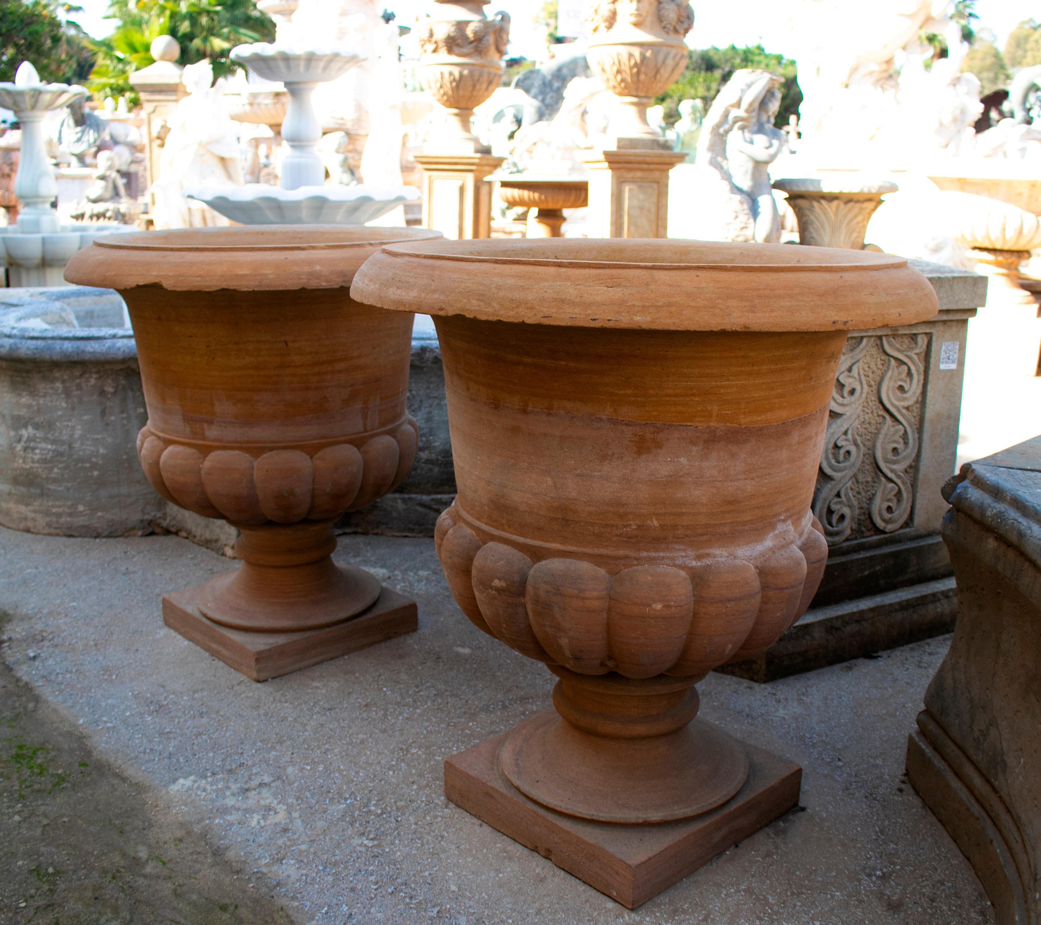 Pair of classical sandstone garden urns.