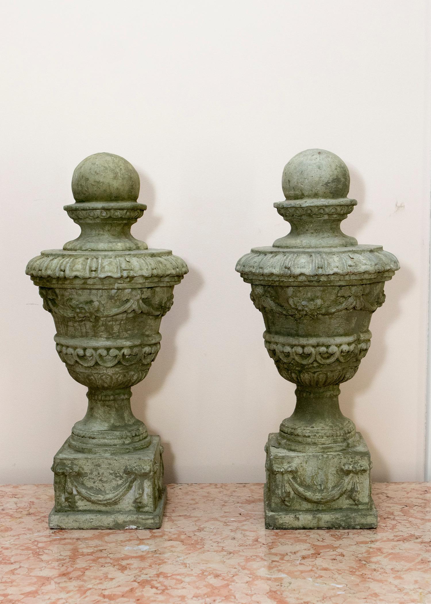 Pair of classical stone finials with ball top, swag and bow decoration, measures: 20