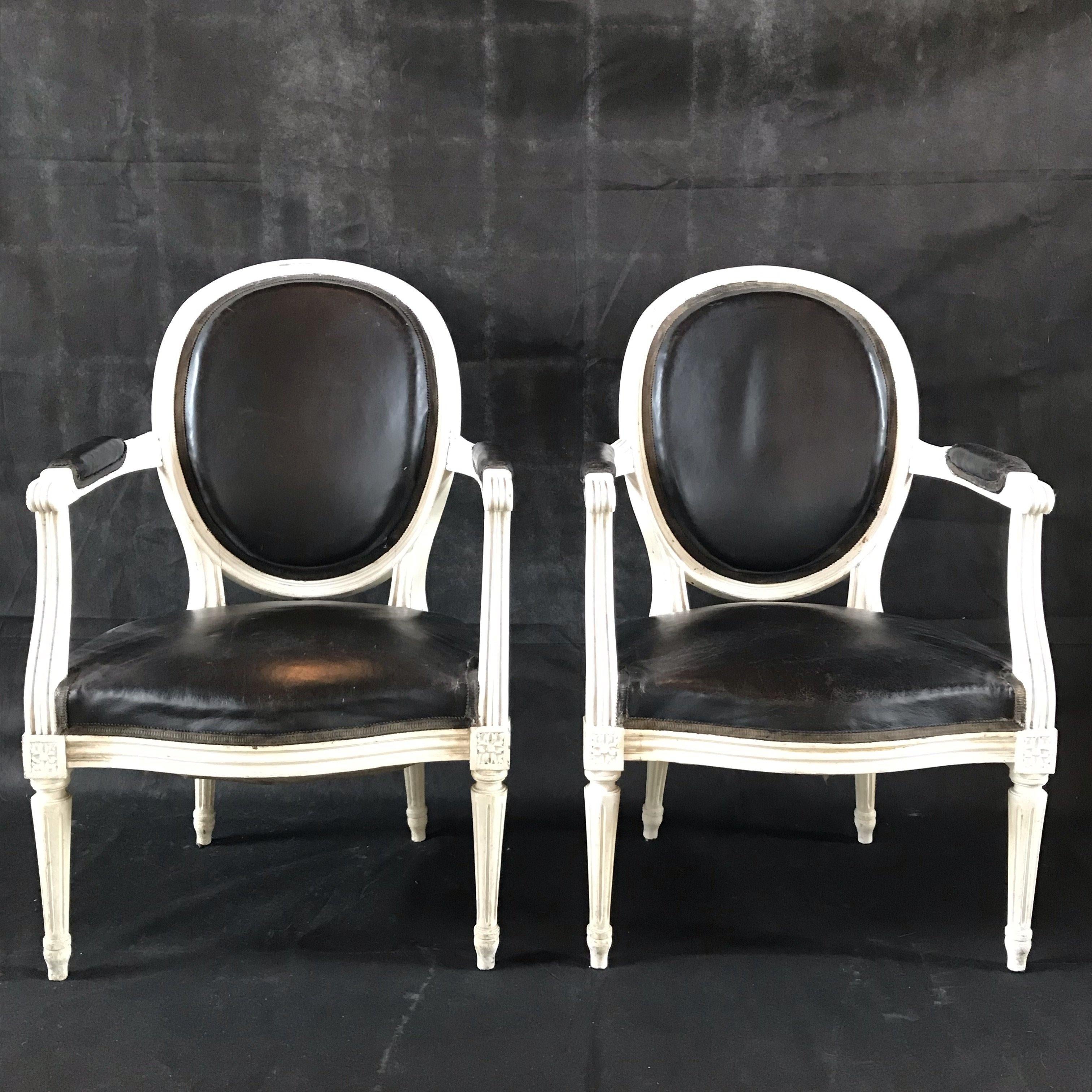 Pair of Louis XVI white fauteuils armchairs in original black leather and
white paint from the 19th century.  #5002
Dimensions:
34.25