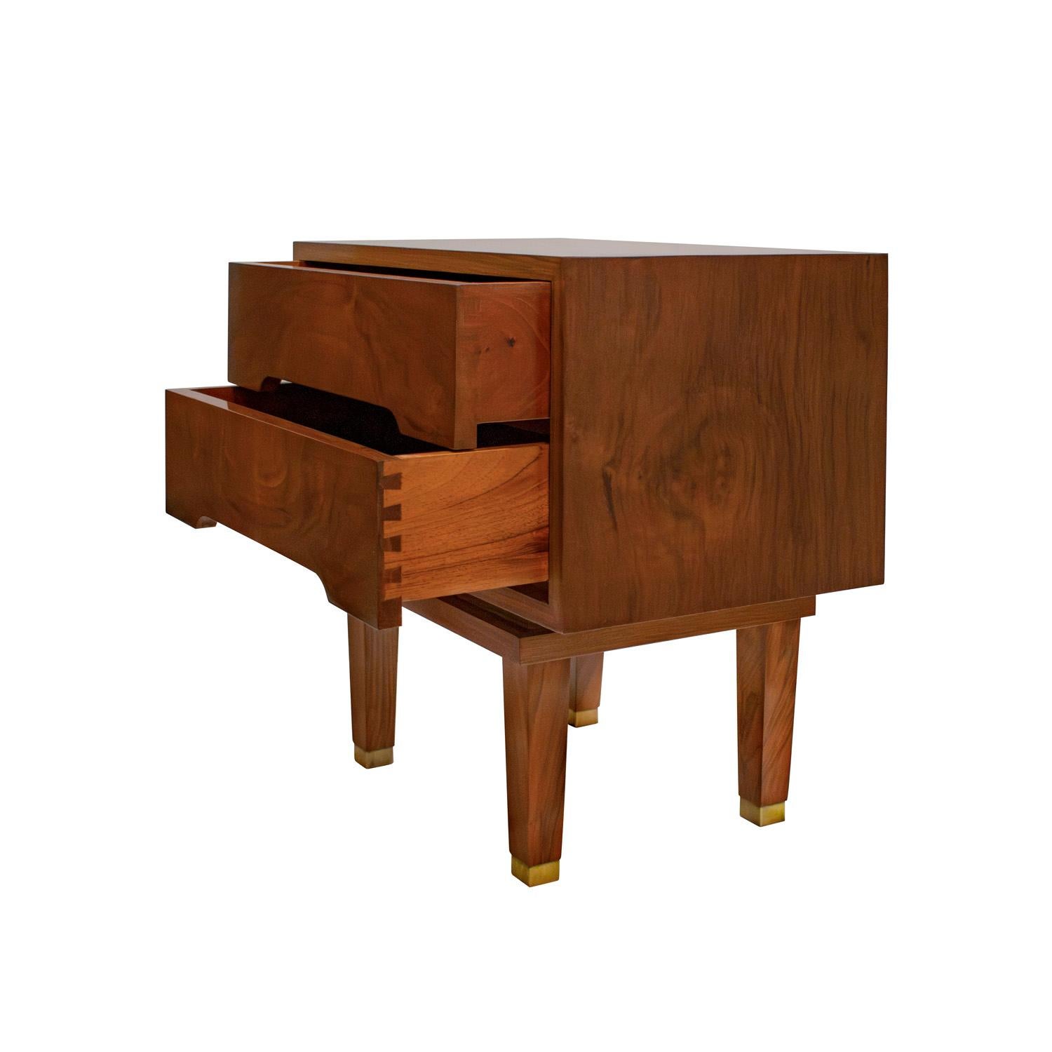 Pair of beautifully made bedside tables in figured walnut, each with two drawers and brass sabots, Italian 1950's.  These bedside tables are very elegant.   

Dimensions for each:
W: 22 inches
D: 14 inches
H: 22 inches