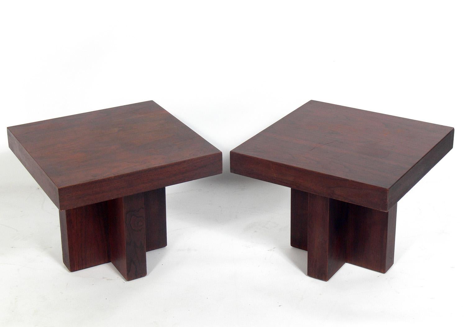 Pair of clean lined walnut end tables, in the style of Milo Baughman, American, circa 1960s. These tables have a clean lined architectural design and can be used as end or side tables, nightstands, or pushed together to be used as a coffee table.